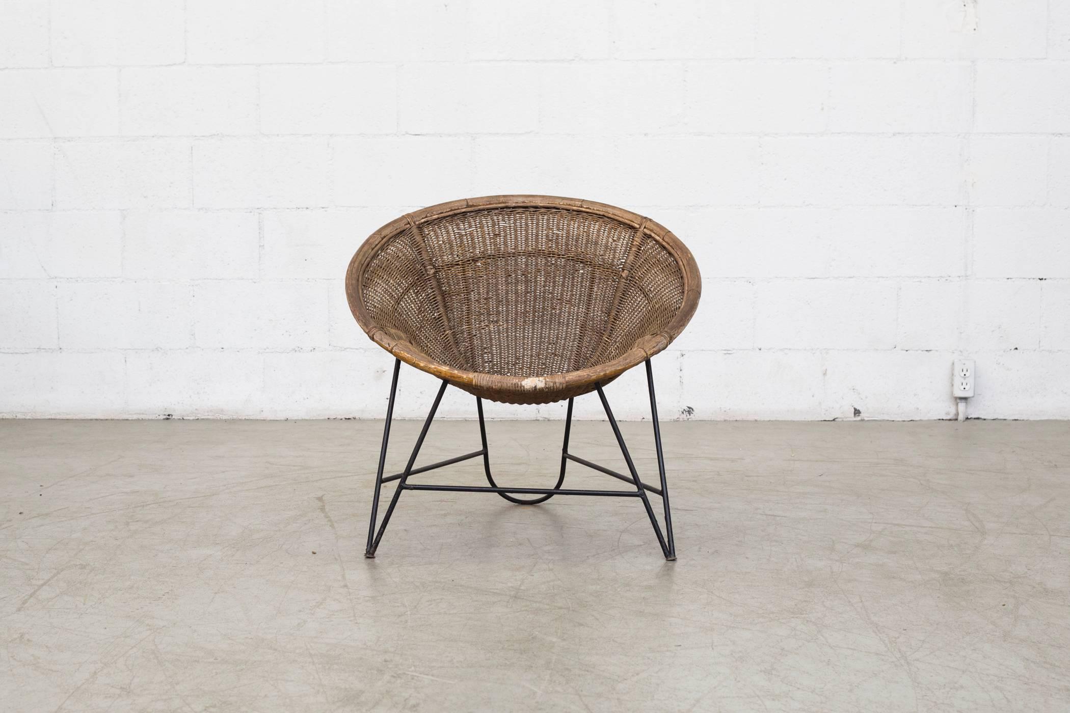 Amazing Jacques Adnet style woven basket chair with woven rattan basket and black enameled metal frame in original condition with visible wear and patina.