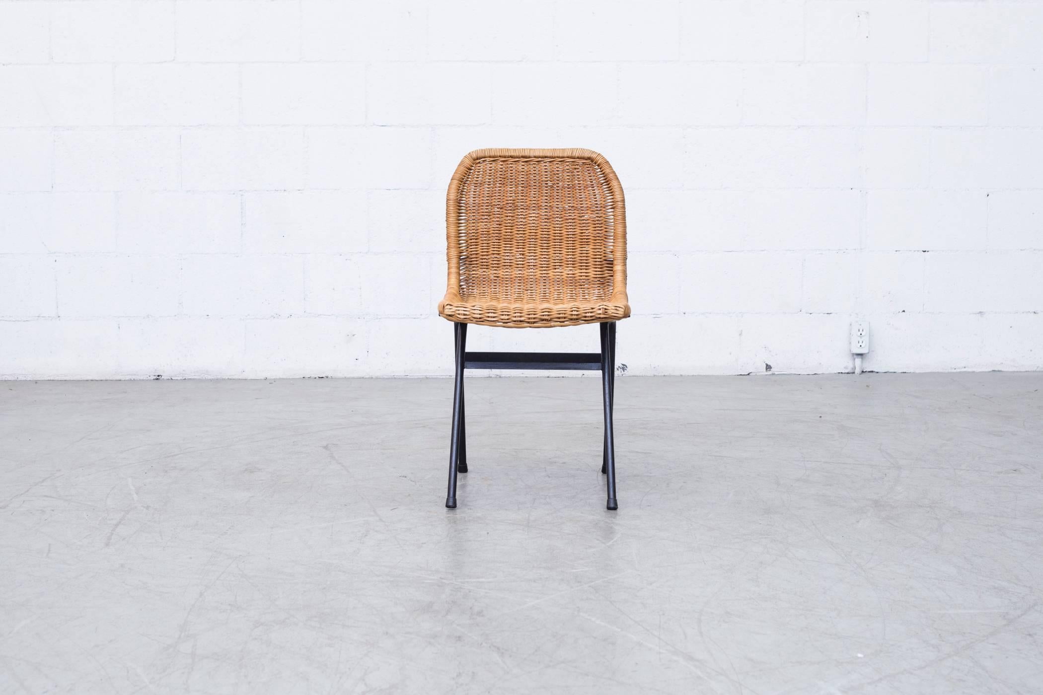 Great set of six dining chairs with woven rattan seats and black enameled metal frames. Visible wear consistent with their age and use. Minimal rattan loss. In original condition.