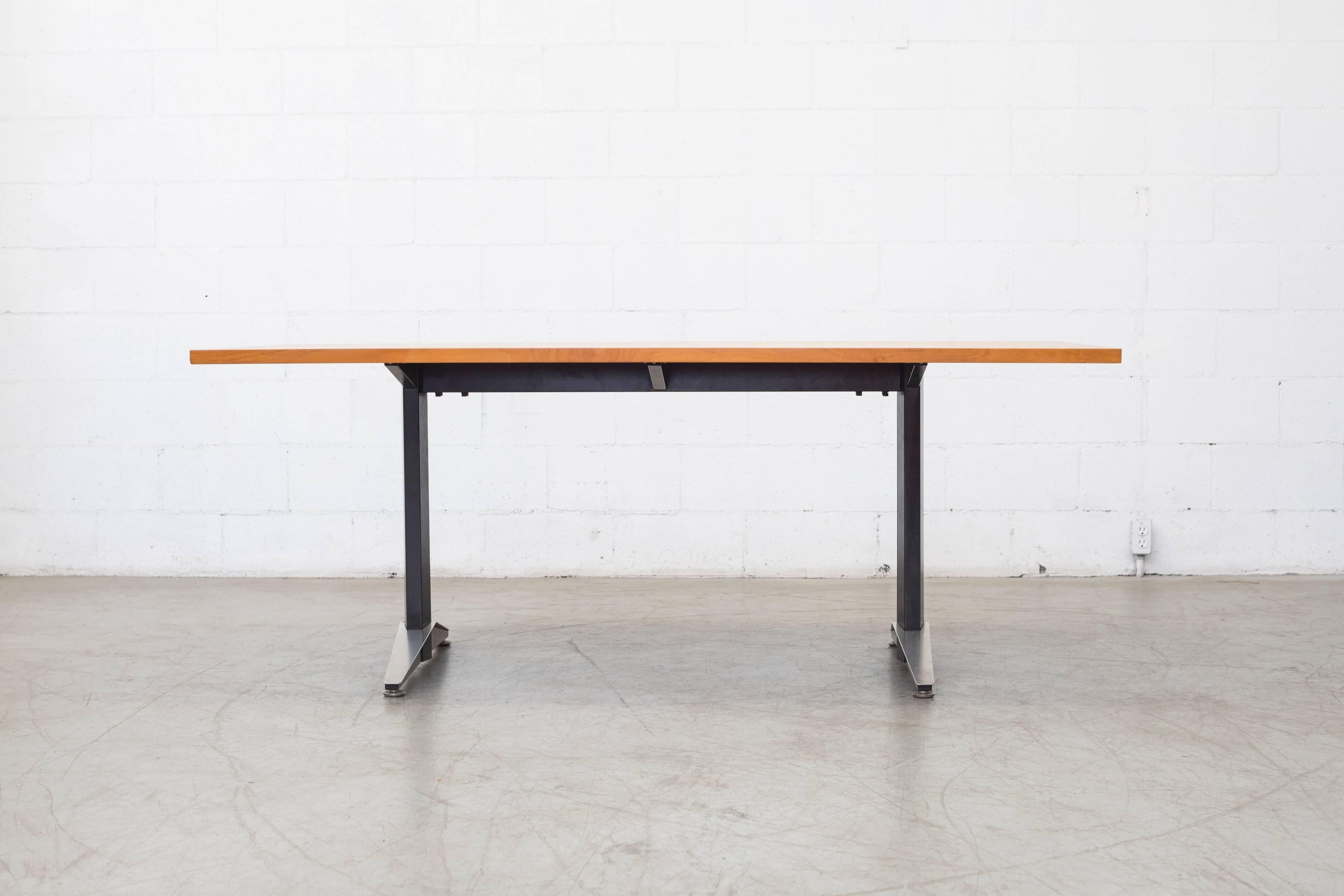 Black steel base with brushed steel accents and original teak top. Perfect for desk, dining or conference table. In original condition with visible signs of wear consistent with its age and usage.
