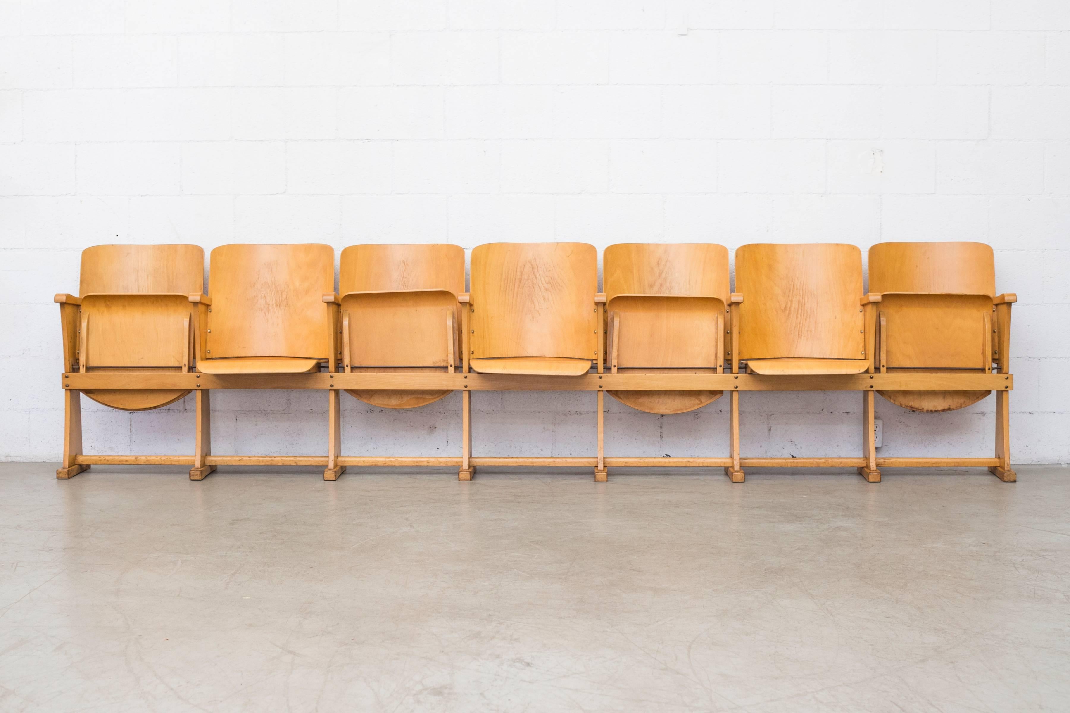 Amazing row of theater seats in birch with flip up seats. Most likely from Sven Markelius. Seven seat length. Original condition with visible signs of wear.