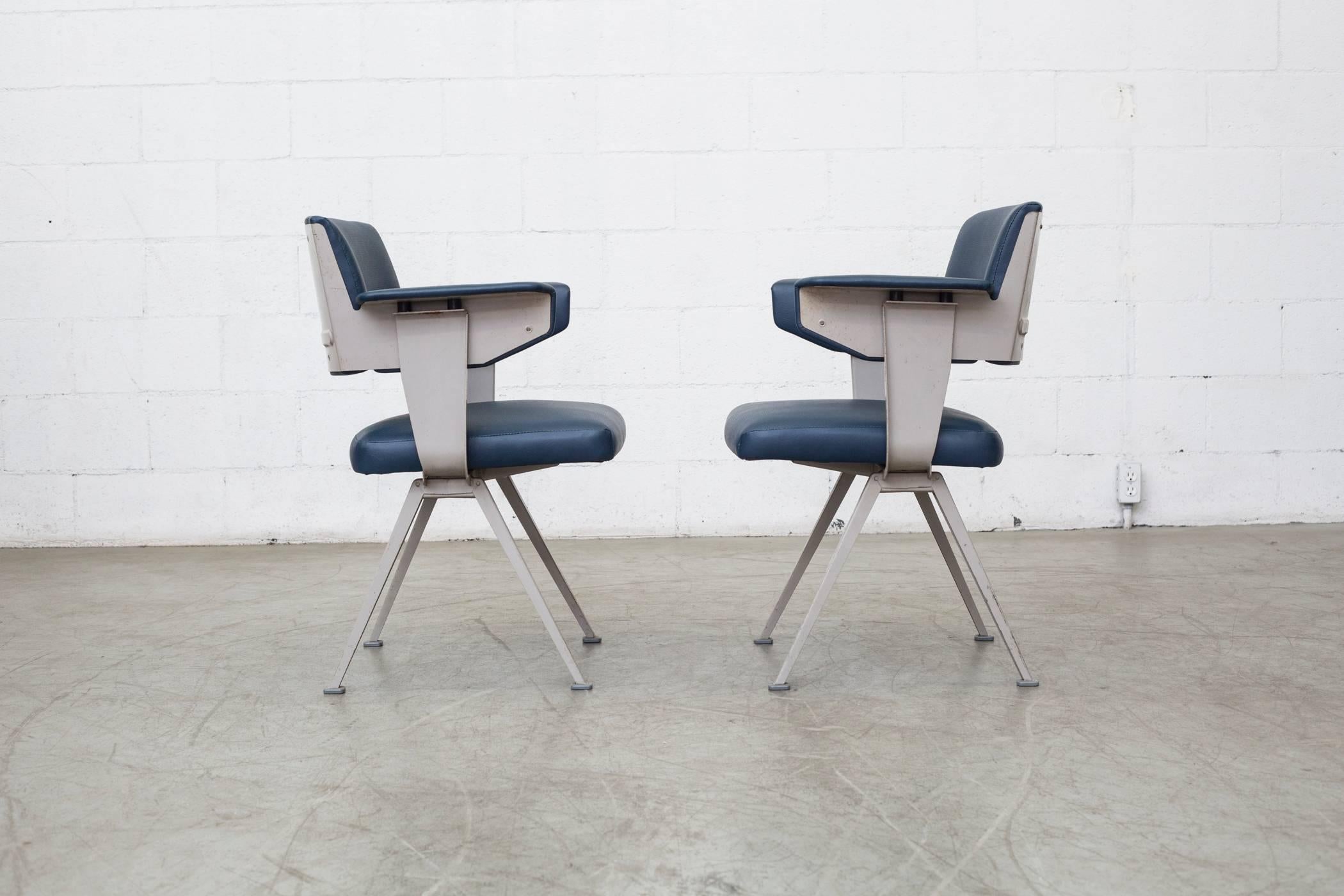 Original dove grey enameled metal frames with new indigo vinyl upholstery with perforated seat and solid back. Frames are in original condition with visible wear and scratching to enamel due to age and use. Set price.