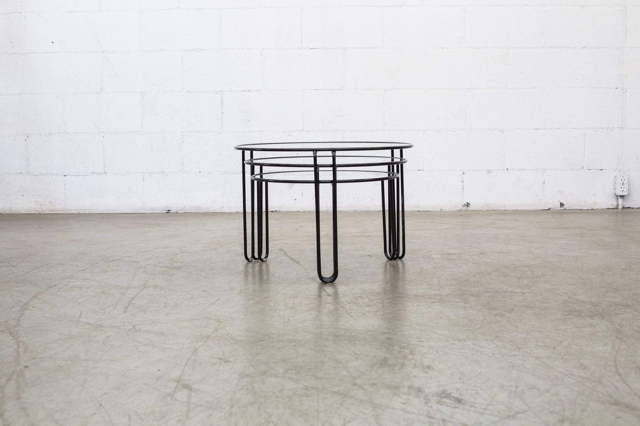 Great set of three black enameled metal Minimalist wire nesting tables with inset glass tops. Good original condition with visible signs of wear consistent with their age and usage. Set price.

(L) 23.25 x 23.25 x 16.25 (M) 21.25 x 21.25 x 14.25