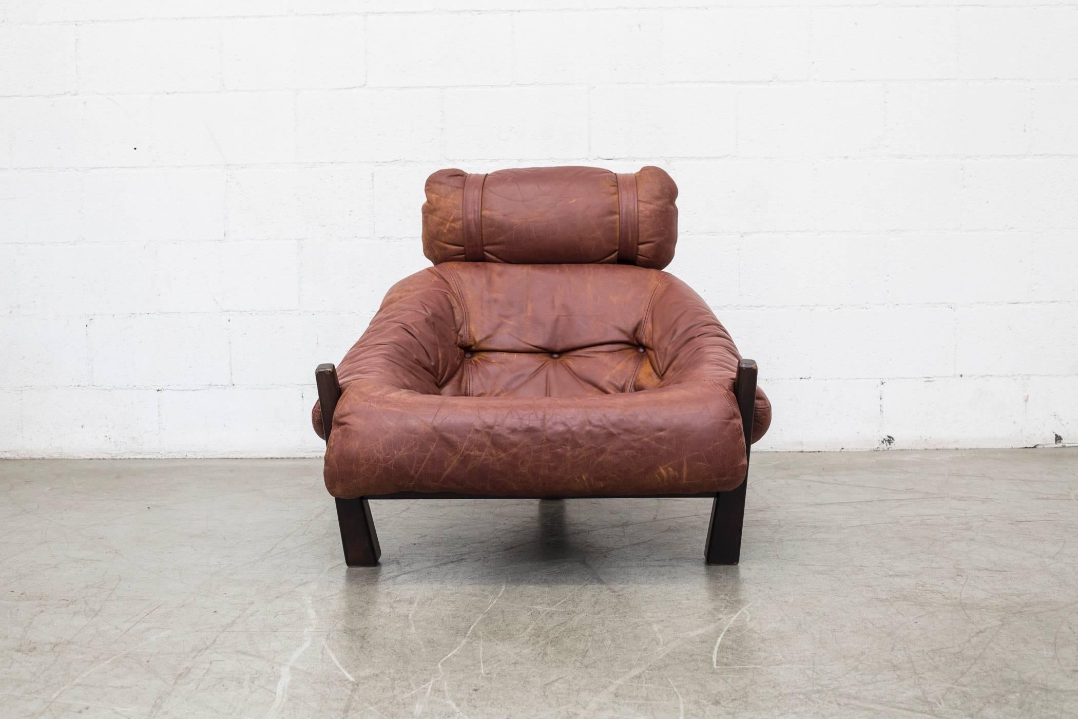 Gerard Van Den Berg lounge chair for Montis, 1970-1972. Tobacco colored leather with visible patina and heavy tripod base frame. Smart tension strap support system. Original condition.