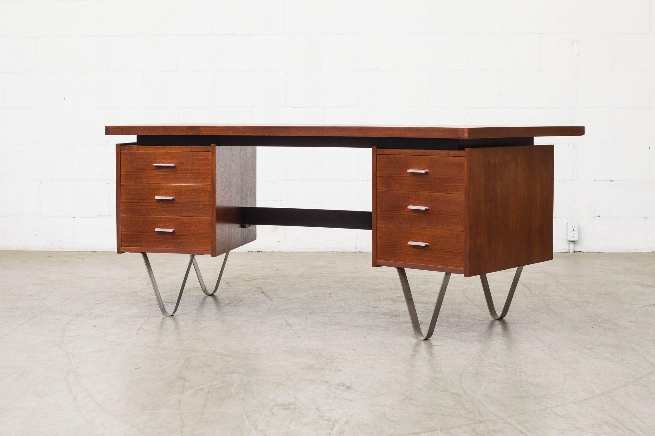 Rare Cees Braakman executive desk with curved top and hairpin legs in teak with black lacquered accents and steel hairpin legs. In original condition with some signs of wear and minor imperfection repair to top.