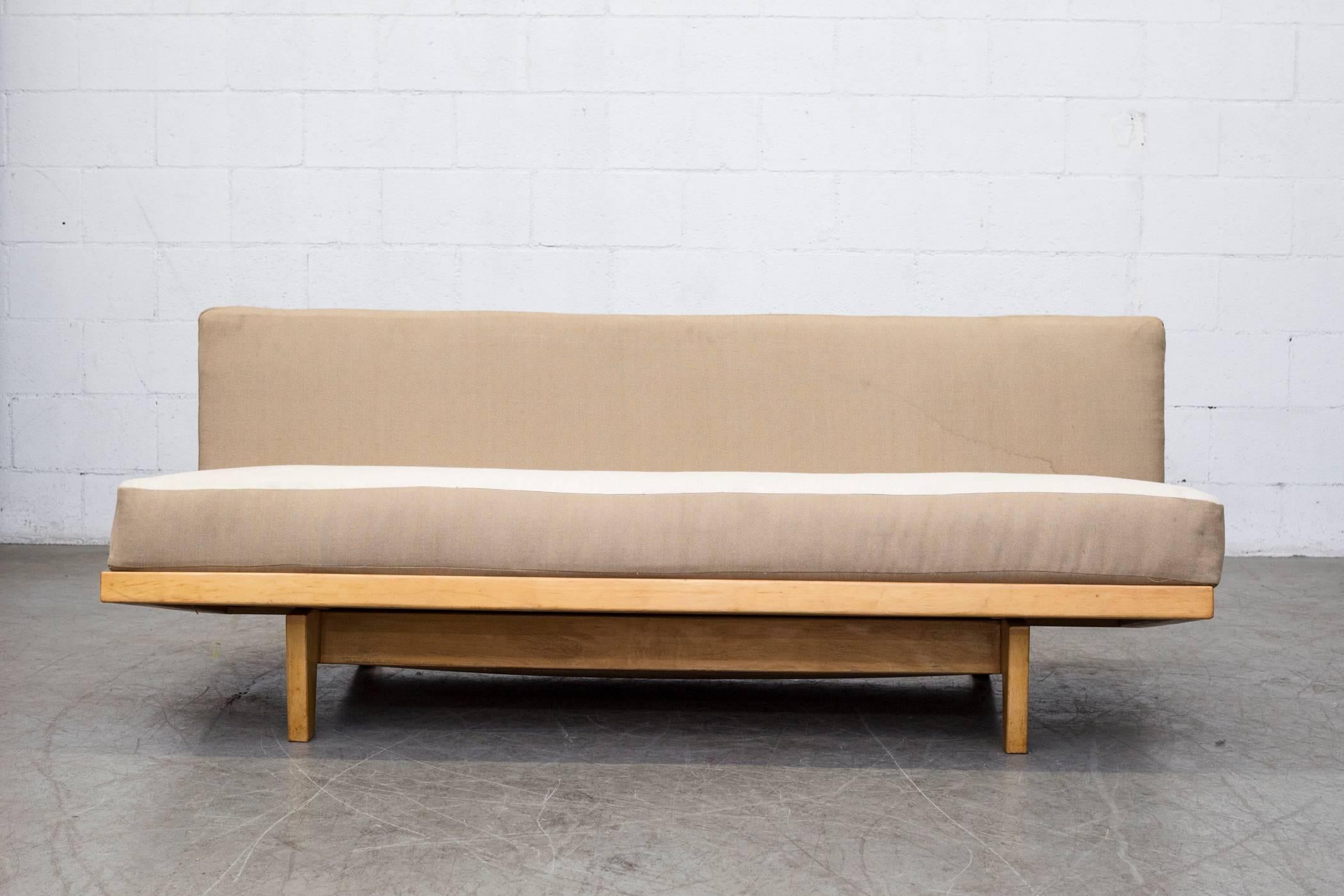 Stunning original sit and sleep model MB09 couch with hidden blanket storage. Birchwood with the original two-tone webbing. Designed by Dirk van Sliedregt in 1951 for UMS Pastoe Holland. Newly Upholstered two-tone upholstery with slight water stain