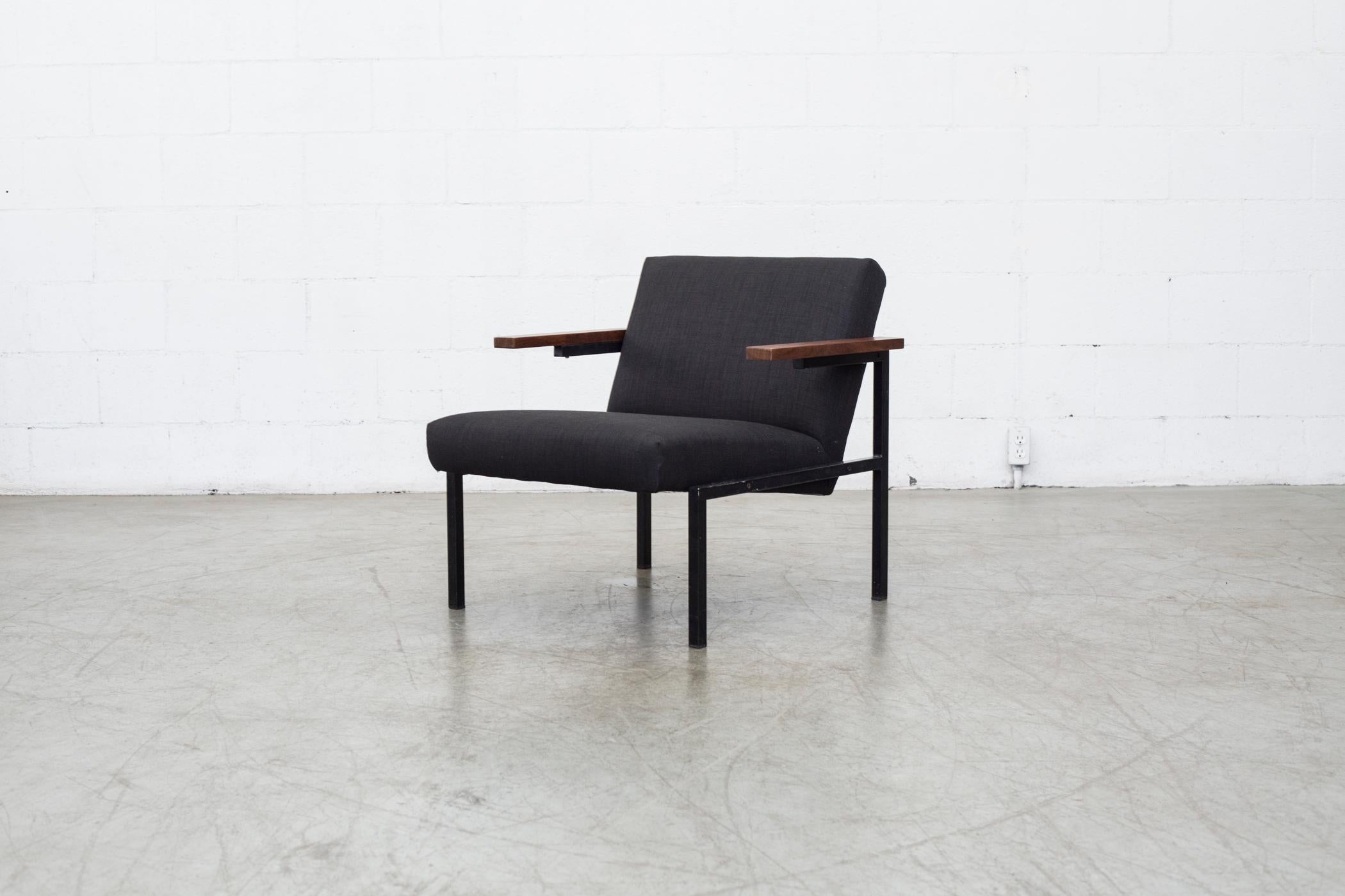 Martin Visser for Spectrum SZ 63 lounge chair with a black enameled metal frame, teak arm rests, and new almost black upholstery. Frame is in original condition. Martin Visser began working for Spectrum in 1954 as designer and head of collection. He