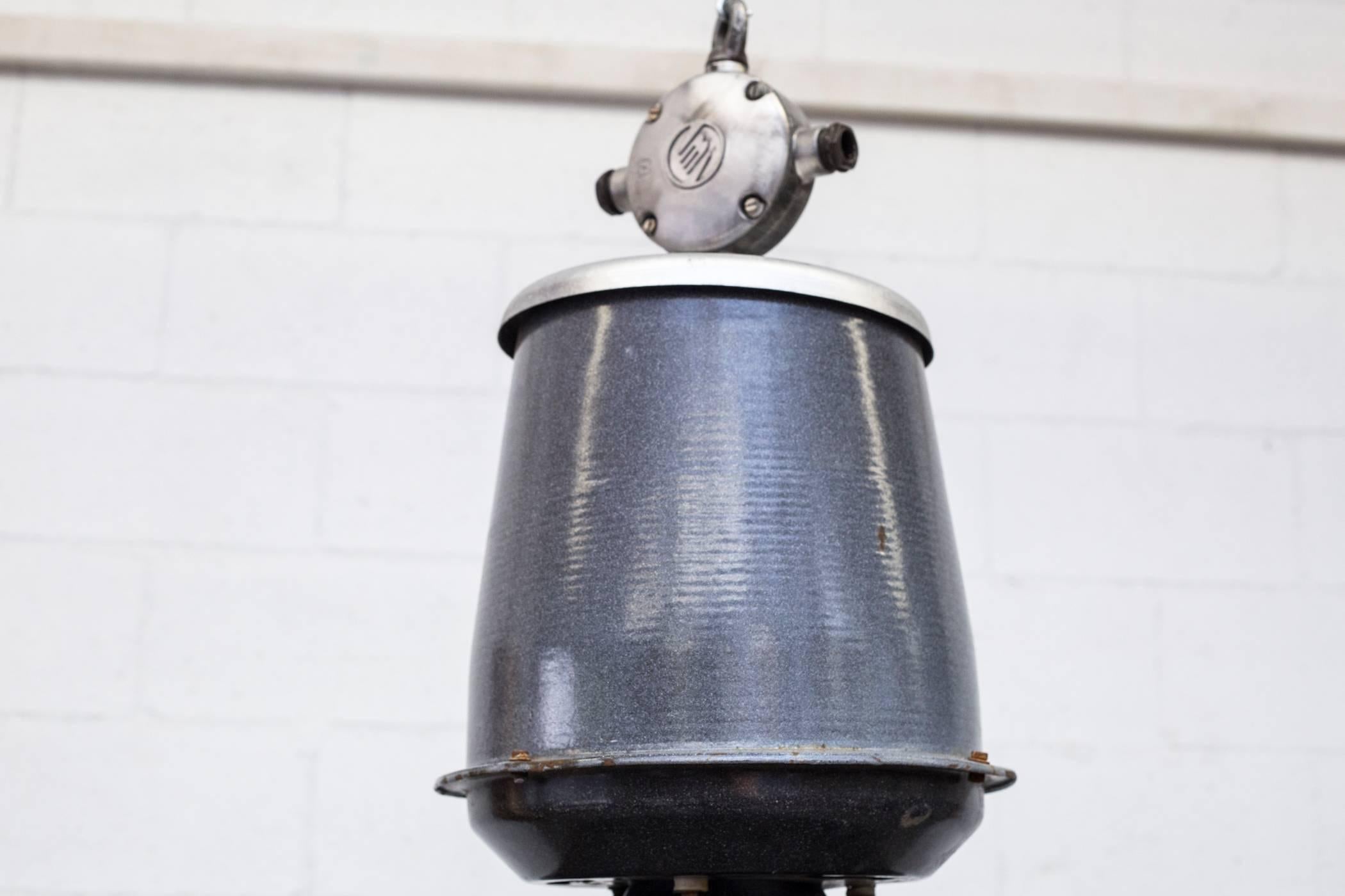 Gorgeous industrial enameled factory ceiling lamps. Speckled grey tops with dark charcoal shades and white enameled interior. All in original condition with visible wear and minimal chipping consistent with their age and usage. Other similar color