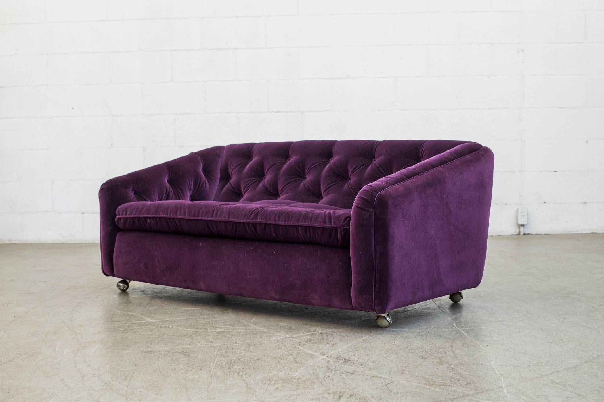 Amazing two-seat Artifort tufted sofa by Geoffrey Harcourt newly upholstered in amethyst velvet sofa on rollers. Matching tufted lounge chair available, listed separately.