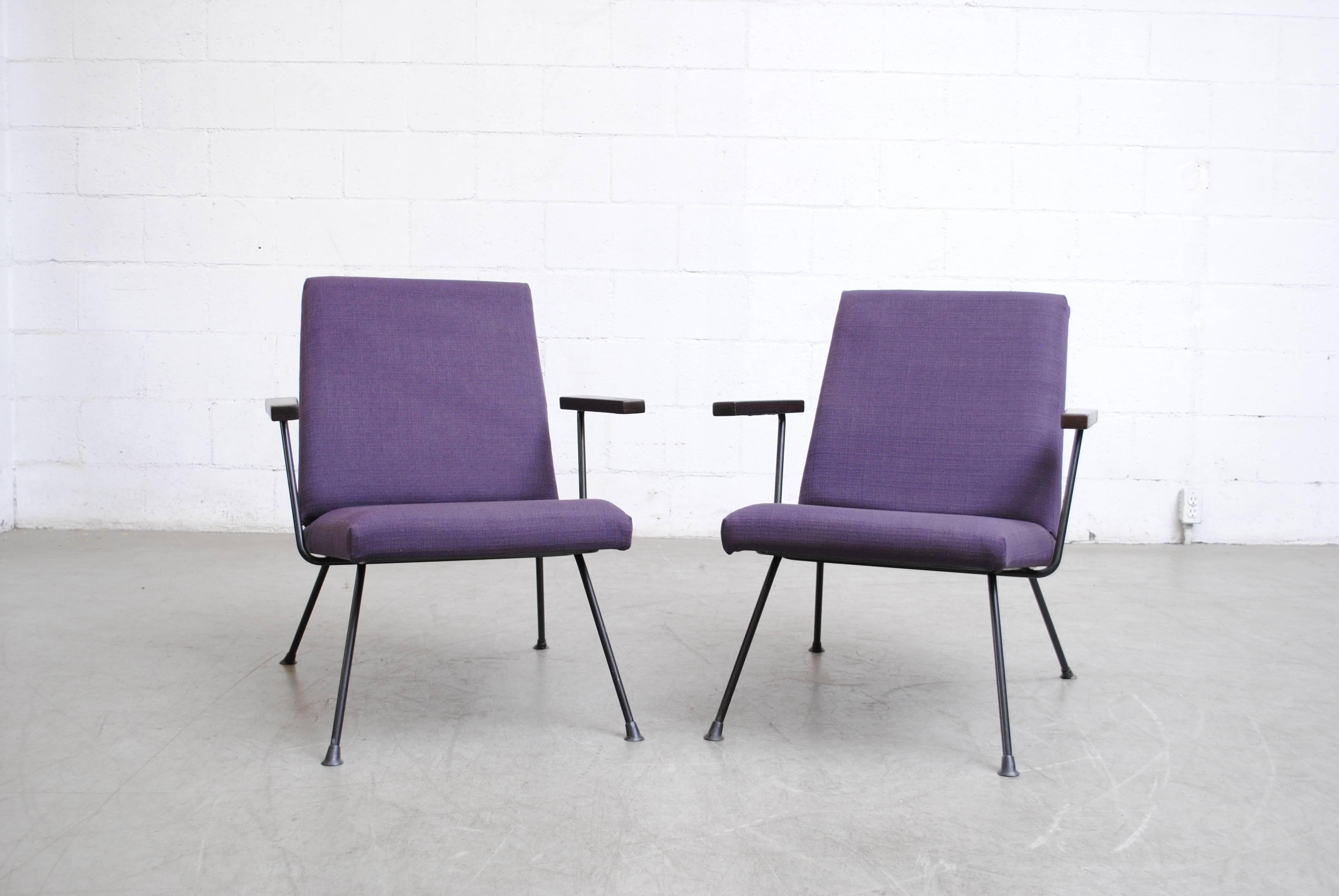 Pair of newly upholstered, A.R Cordemeyer designed, plum Gispen 1409 chairs with wenge armrests and black enameled metal frame. Frames in good original condition. Fabric color is more vibrant in the photo than in reality. Manufactured in 1959. Set