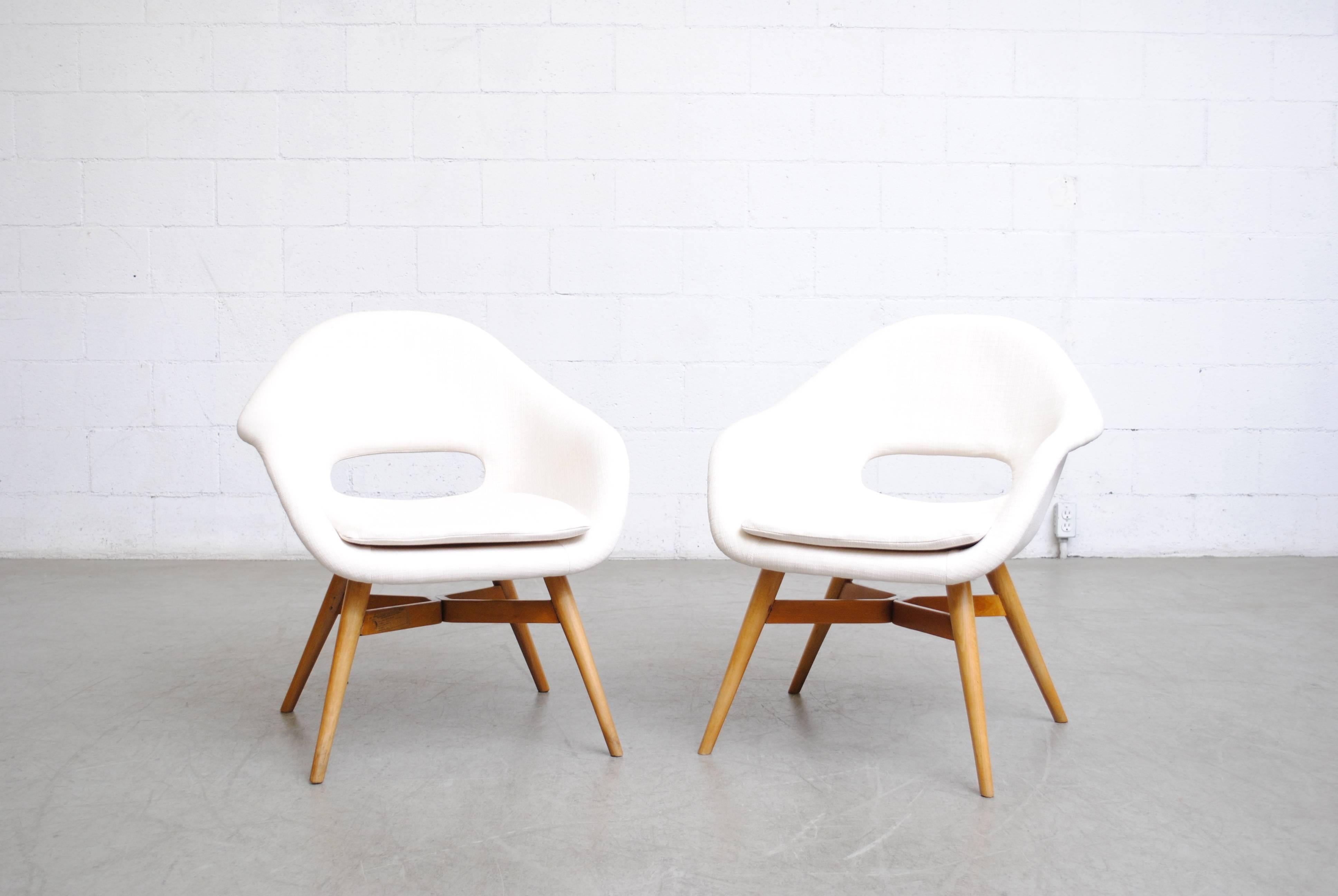 Newly upholstered modern bucket chairs with Saarinen style cut-outs by Miroslav Navratil in snow white upholstery with original birch frame in good original condition, other similar styles available, 100+ in original upholstery. Set price.