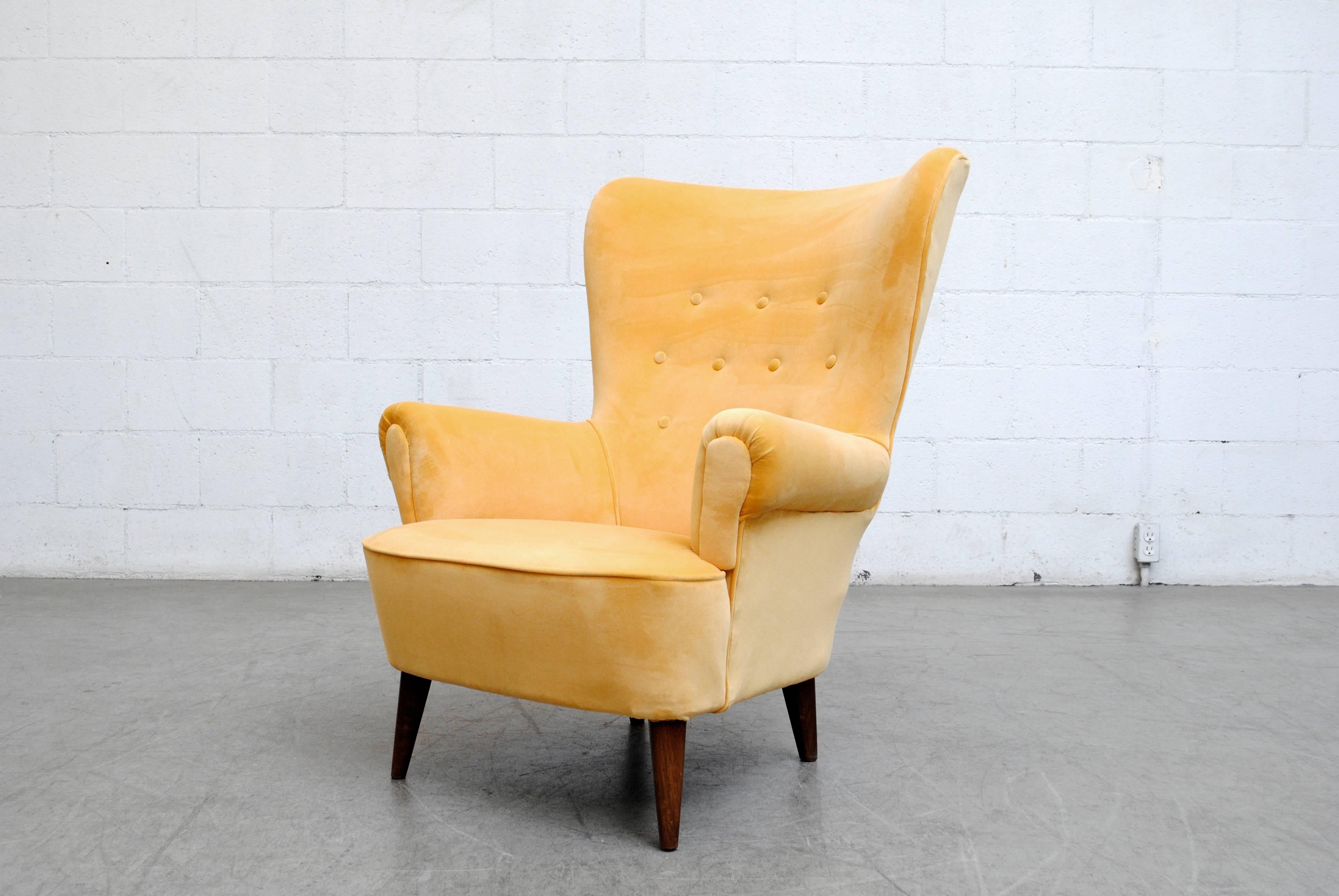 Impressive Theo Ruth winged back lounge armchair for Artifort in brand new canary yellow velvet upholstery. Legs are lightly refinished.