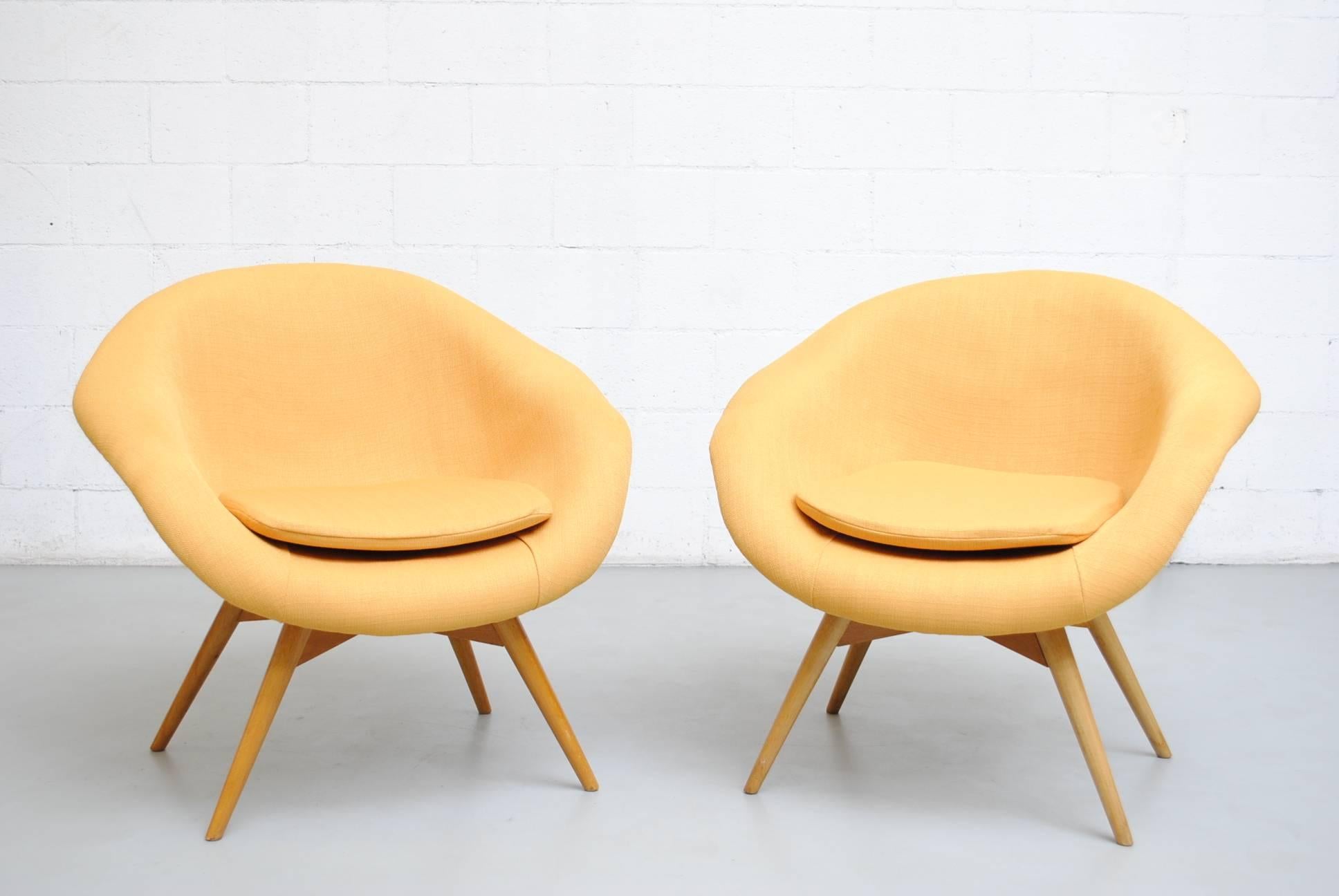 Pair of newly upholstered sunshine yellow bucket chairs by Miroslav Navratil frames are in good original condition. Other similar styles available in assorted colors (listed separately). Also available in original upholstery.