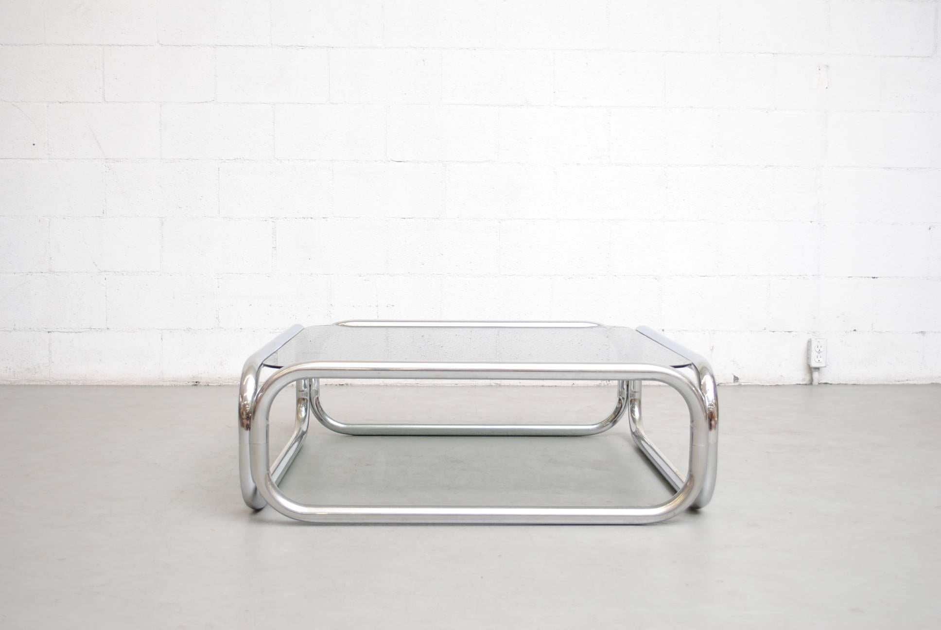 Impressive fat chrome tubular coffee table with smoked glass top. Superb design. Visible wear consistent with its age and usage.