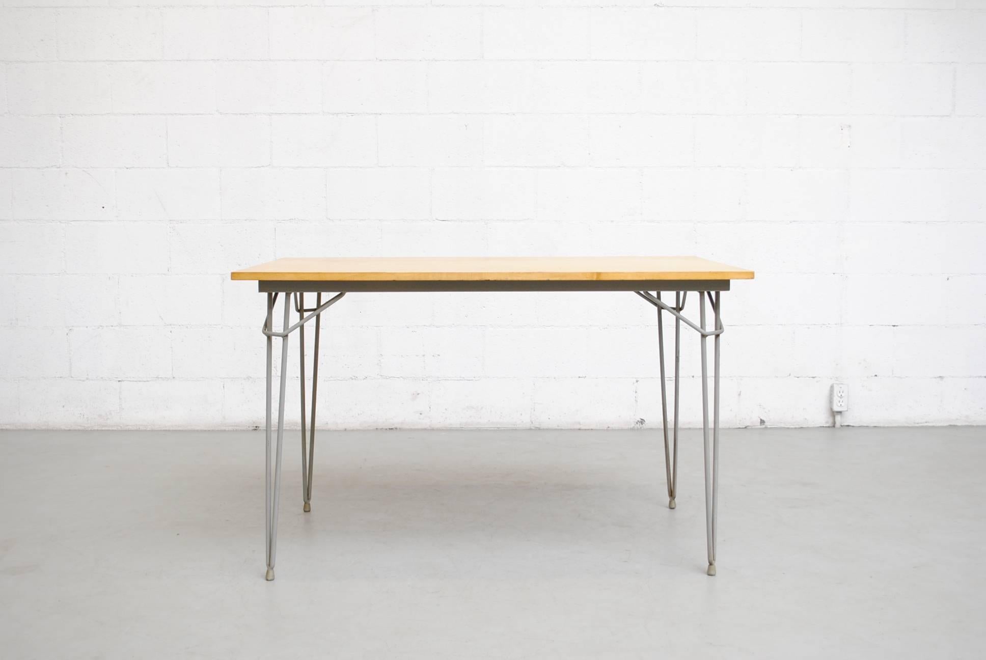 Rare wood topped Kembo table by W.H. Gispen for Kembo with original grey enameled metal hairpin legs with original rubber foot caps. Visible signs of wear consistent with its age and usage. Original condition.