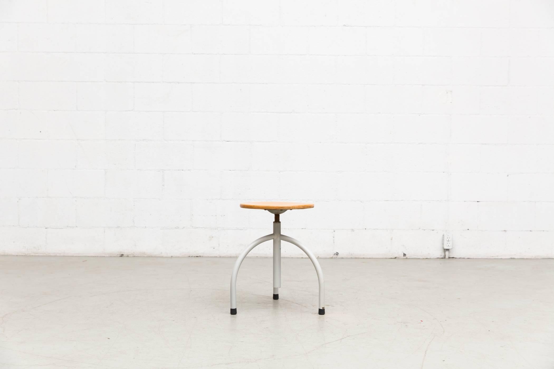 Tubular steel with 13.5" birch wood seat, adjustable height from Oosterwolde for University of Nijmegen. Both in original condition, Visible wear to the enamel and wood top. Set price.