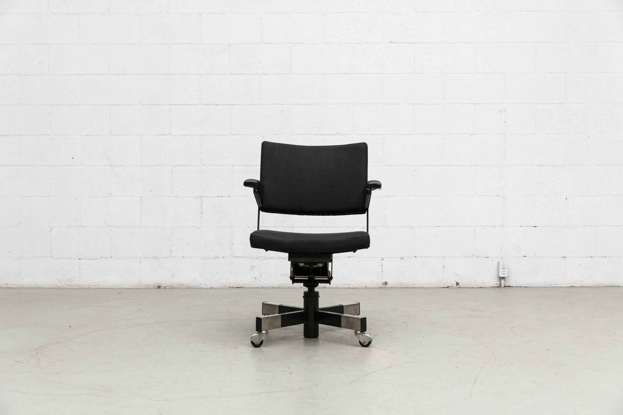 Newly upholstered Industrial rolling office chair in almost black fabric with black enameled metal frame by A. R. Cordemeyer for Gispen with adjustable seat height. Handsome office chair. Others available, Listed separately.