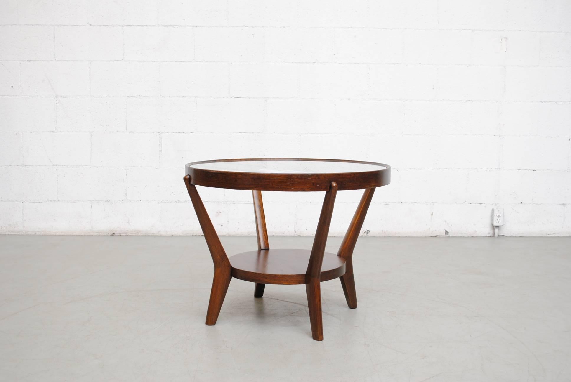 Round functionalist dark wood side table with inset glass top and wood lower shelf. Designed by Antonín Kropácek and Karel Koželka. The table was part of a set that won silver at the Milano Triennale of 1947. In original condition. Others available