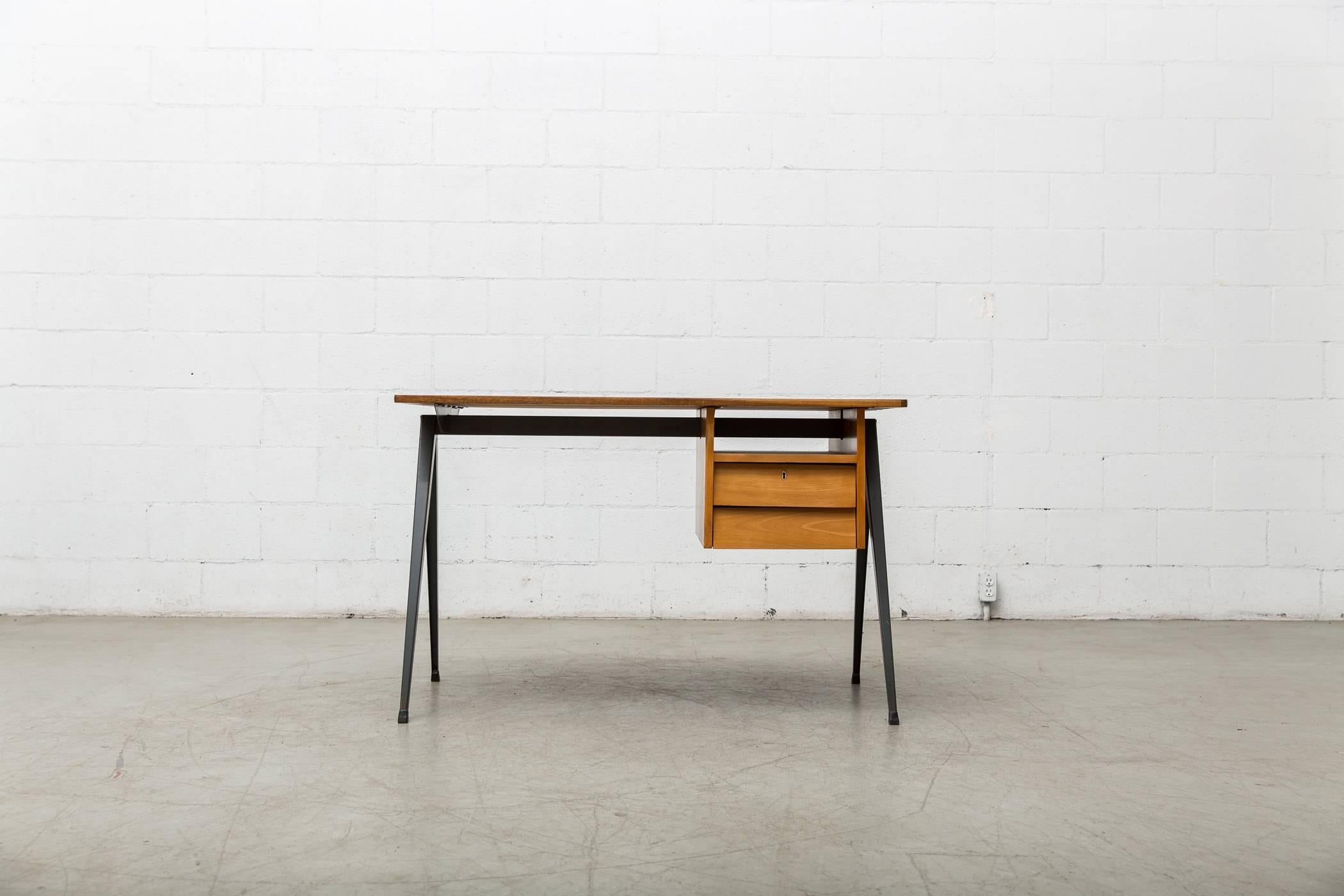 Wood desk for Marko with faux wood Formica top and grey enameled metal prove-style legs. Two natural wood drawers and cubby on right hand side. Comes with Mid-Century industrial school chair with arms and matching prouve style legs (as pictured). In