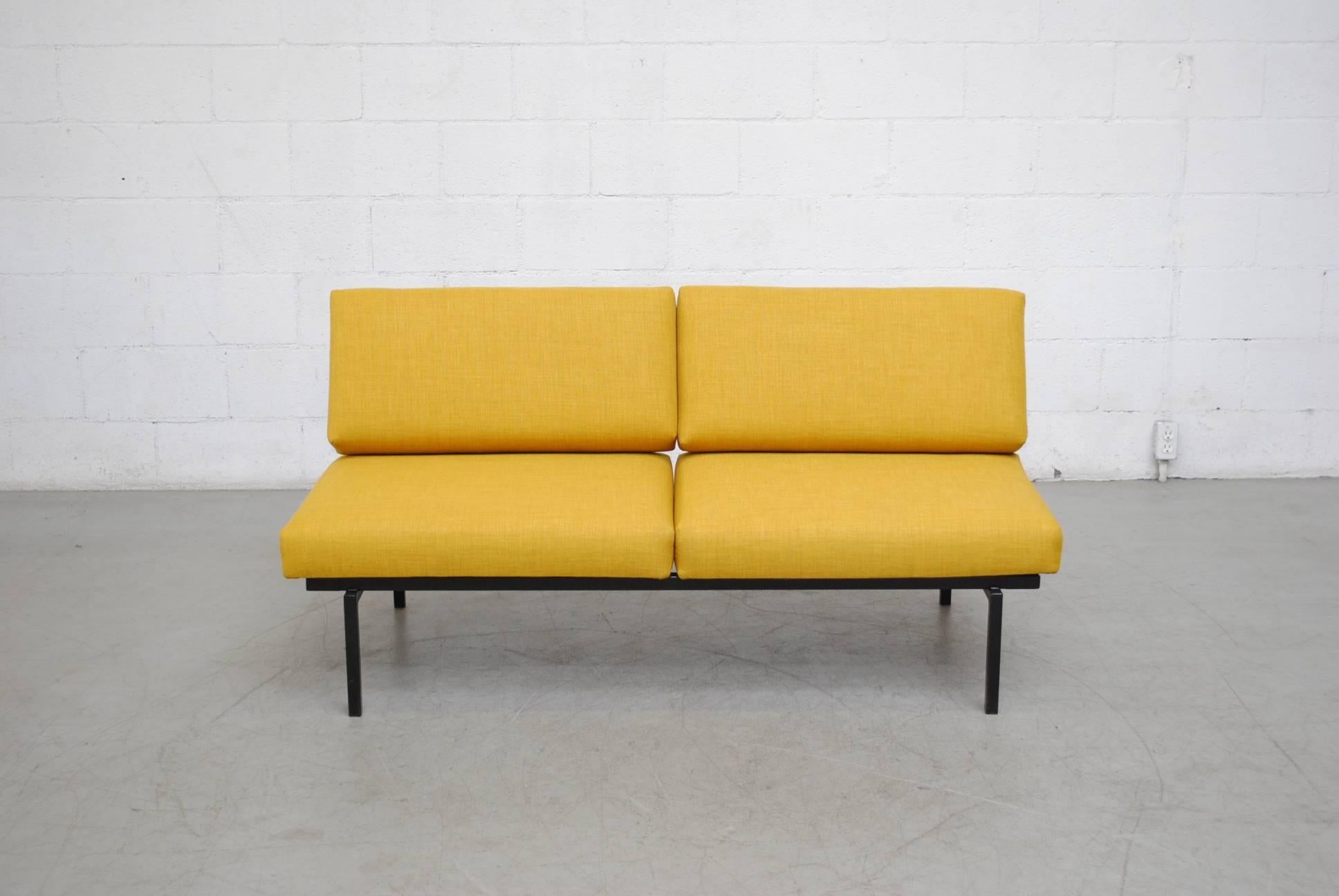 Coen de Vries sofa - daybed newly upholstered in sunshine yellow fabric. Black enameled metal frame. Easily transforms from sofa to daybed as pictured. Very good original condition. When unfolded as a daybed it measures 88.25 x 31.75 x 18?/26.125.