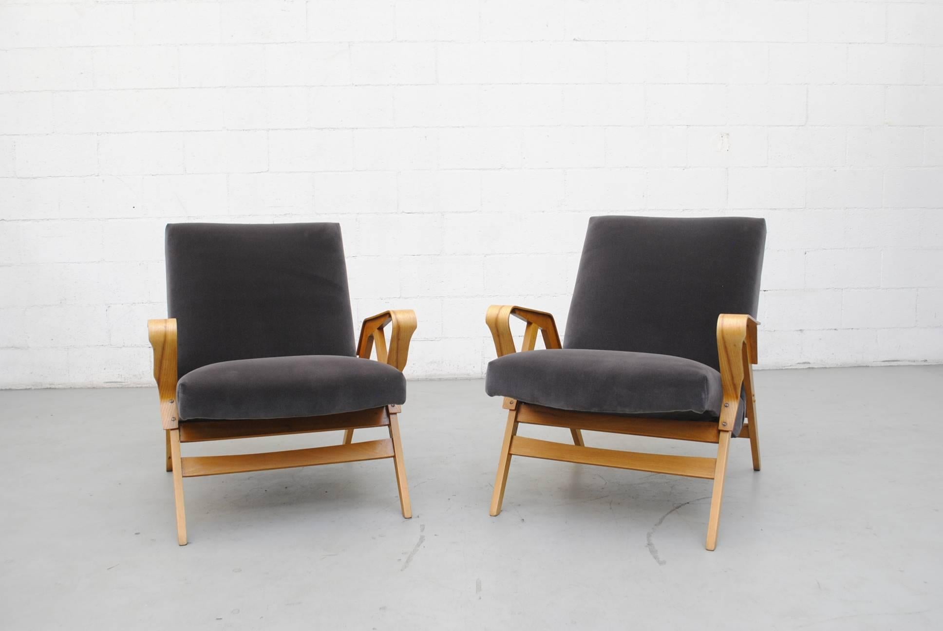 Gorgeous pair of Tatra lounge chairs with bent beechwood frames. Elegantly curved arm rests, 1960s Czechoslovakia. Newly upholstered in beautiful seal grey velvet. Frames in good original condition. Set price.