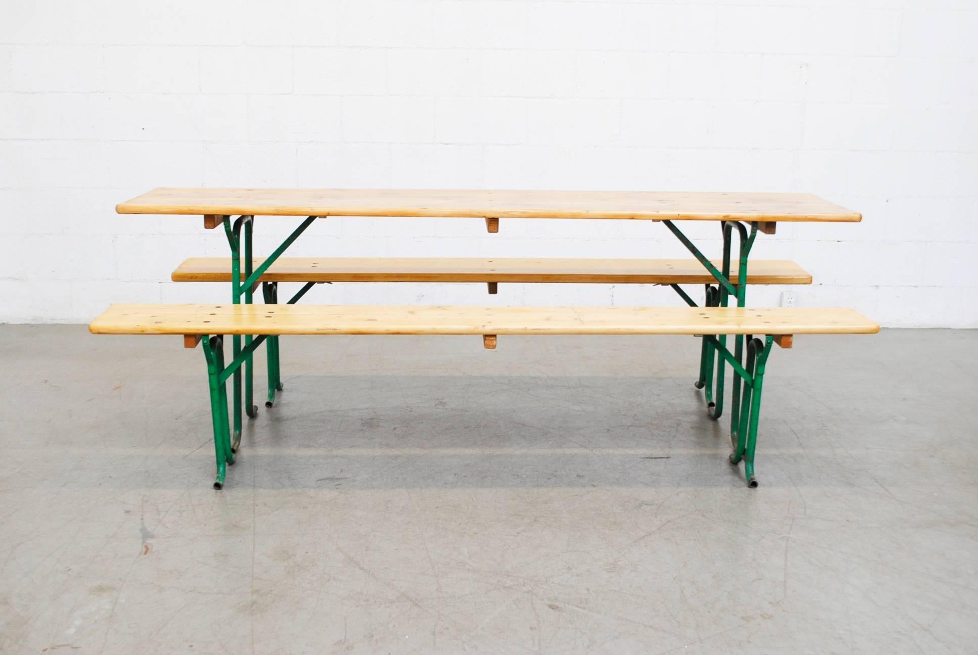 Natural wood German beer garden table and bench set. Newly refinished with marine coating. Tubular green enameled metal frames in original condition with visible wear. Similar sets available, listed separately. Benches measure 86.5 x 10.5 x 18.5.