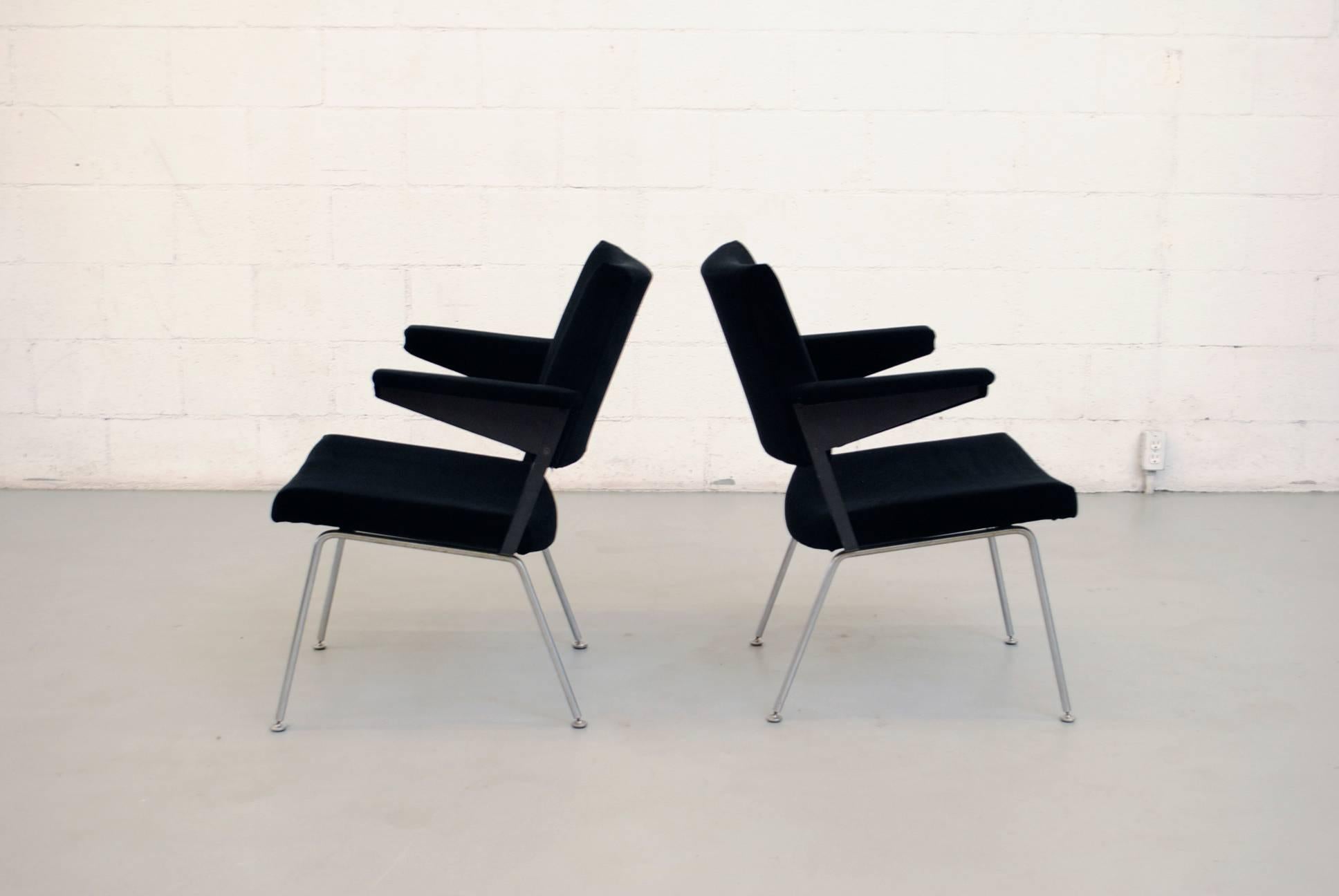 Cordemeyer designed, great architectural pair of chairs newly upholstered in black velvet with wide body, Prouve style arm rests, black enameled metal frame and brushed steel legs. This particular model is a lower office lounge chair version of the