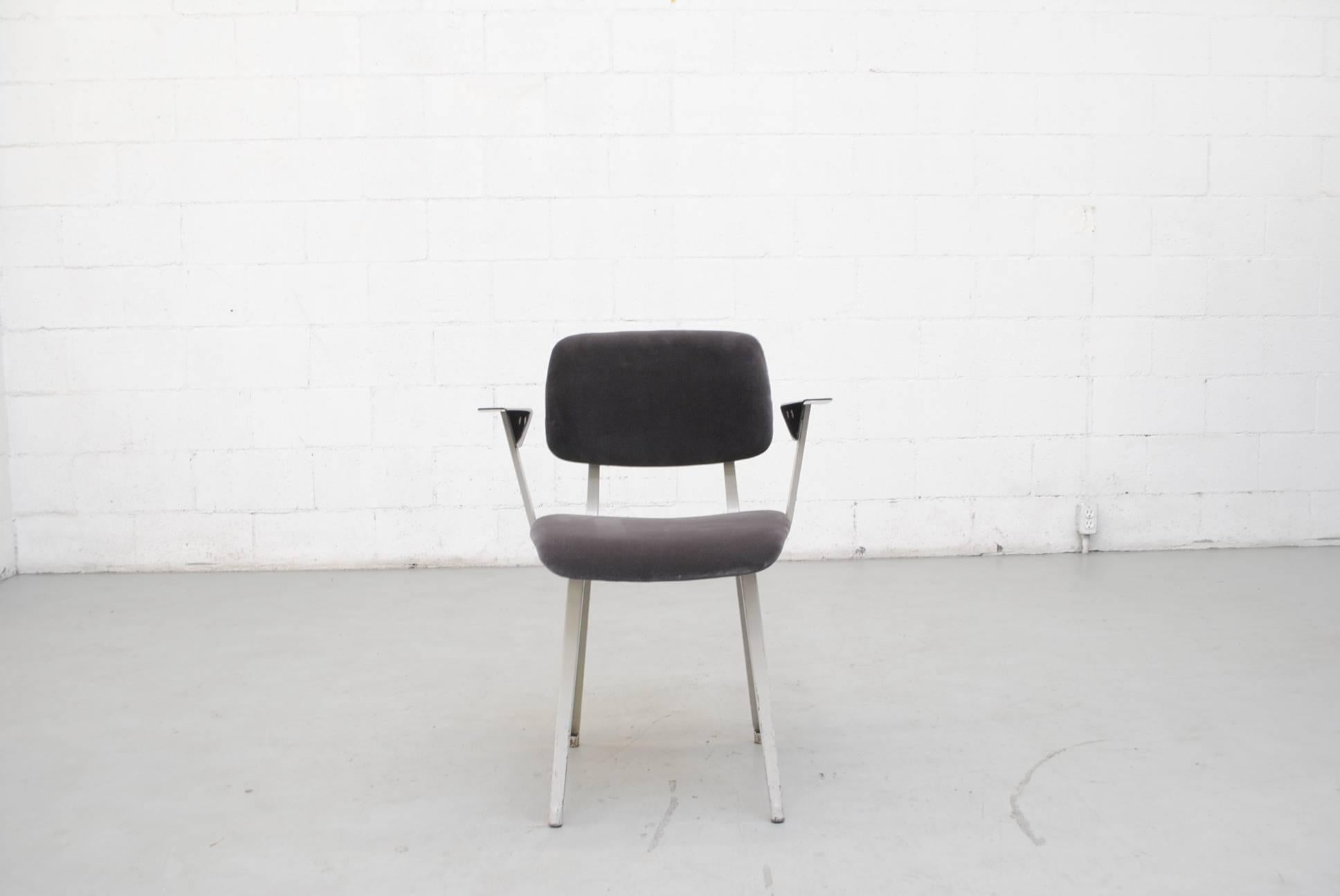 Friso Kramers most infamous Industrial chair with light grey sheet metal chairs, signature angled Melamine arm rests and new seal grey velvet upholstery. Frames in original condition with visible wear and scratching to the frames. One chair has a