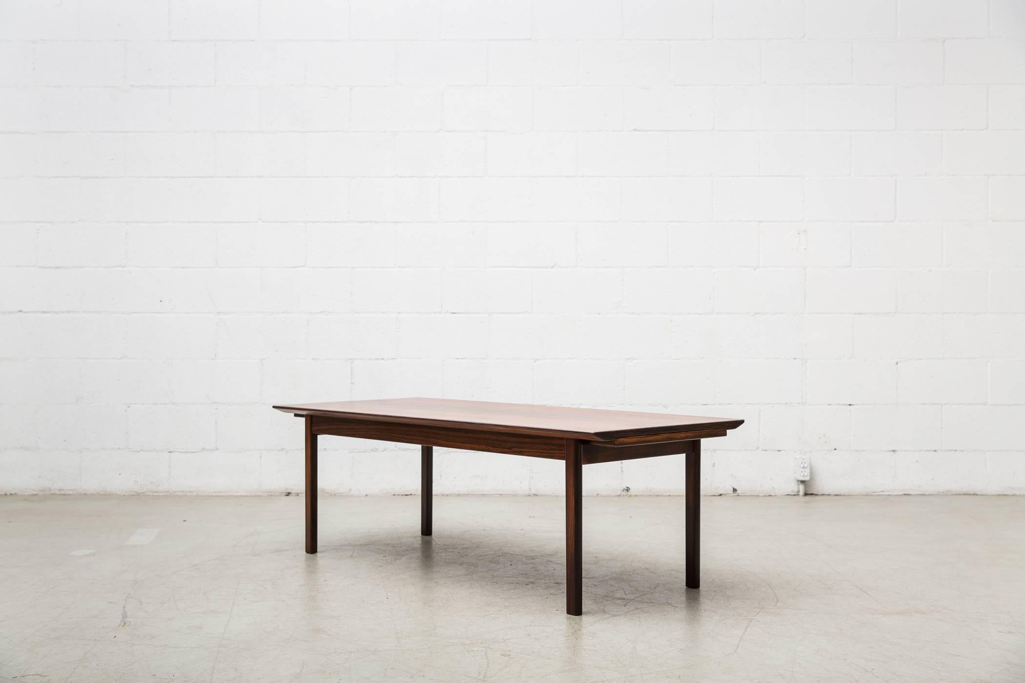 Smart Swedish rosewood coffee table for Seffle Mobelfabrik with two formica topped sliding trays. In good original condition, some signs of wear consistent with its age and usage.
