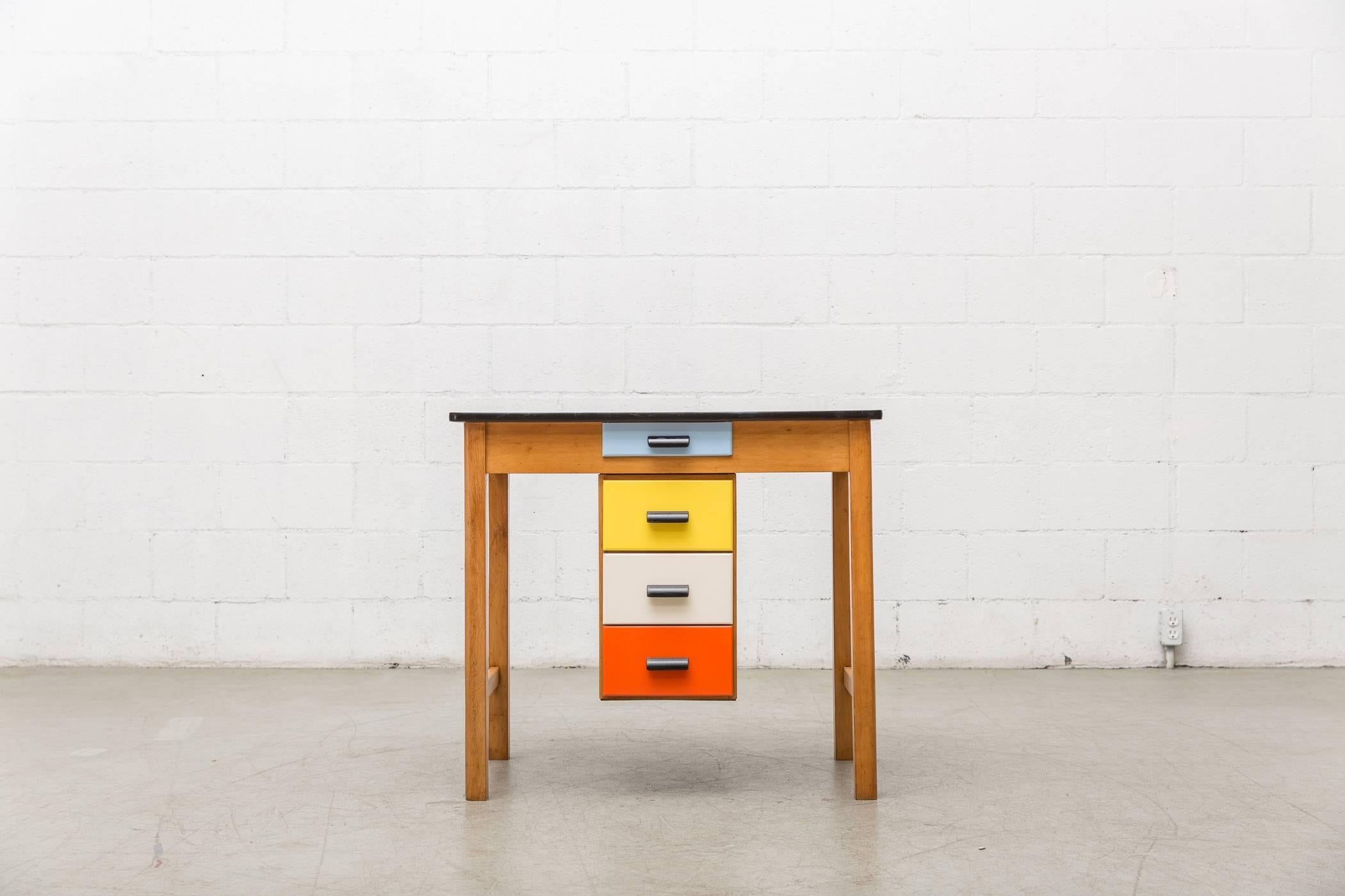 Cool Little Mid Century Drawing Desk with Multicolored Drawers which Slide From Left To Right. Printed Formica Top. Good Original Condition