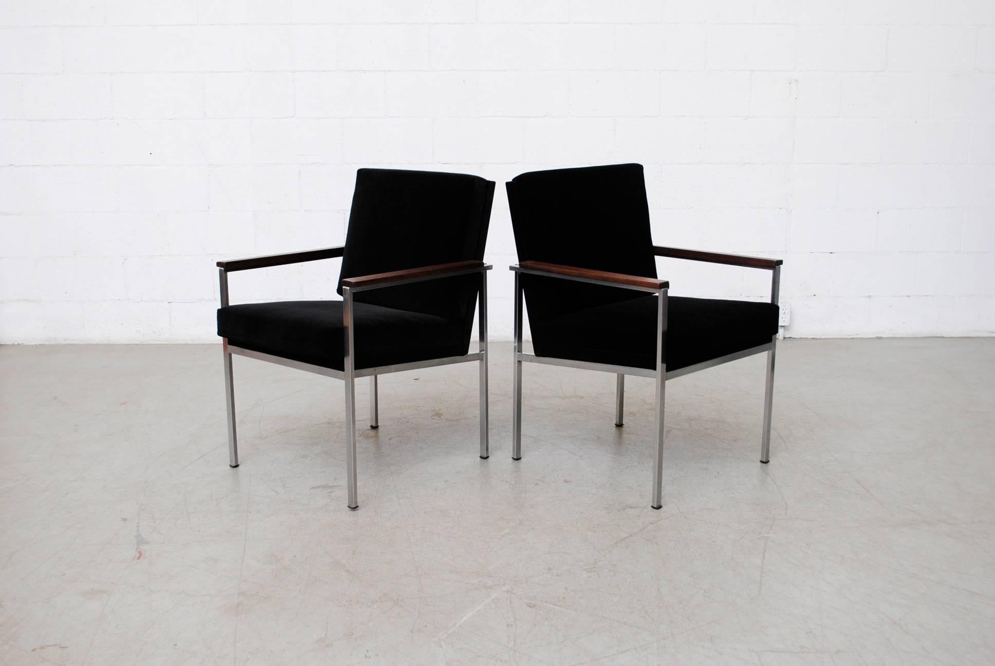 Pair of handsome architectural chrome framed arm chairs with new black velvet upholstered seating and teak armrests. Good original condition, some wear to frame. Set price.