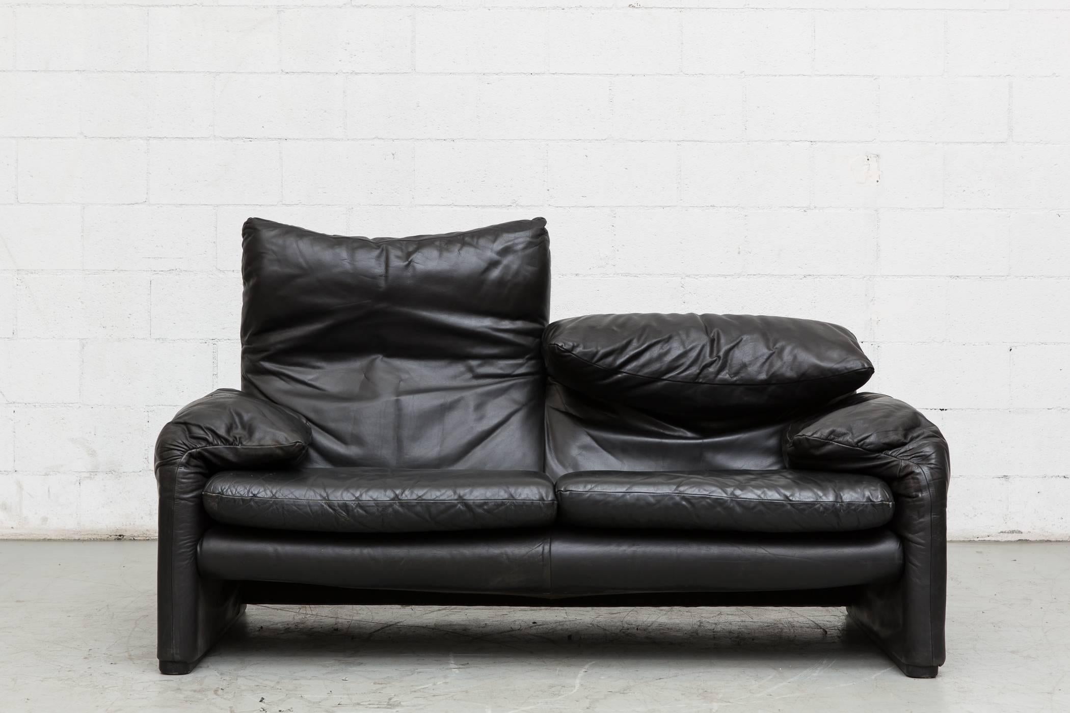 Black leather Maralunga loveseat by Vico Magistretti for Cassina in good original condition with visible patina, light scratching and wear consistent with its age and usage.