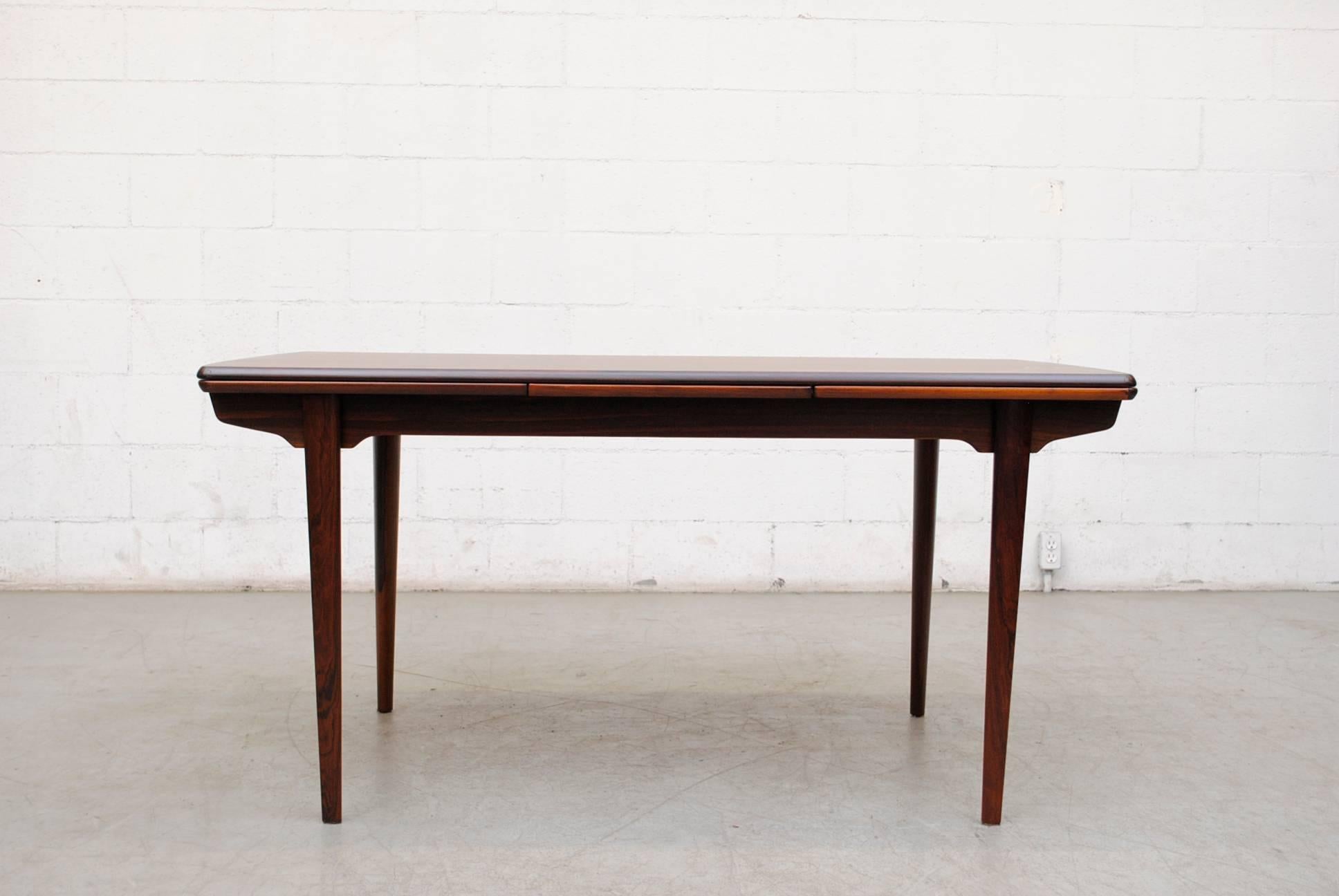 Gorgeous Danish Rosewood Dining Table by H.P. Hansen with Pull-out Leaf Extensions. Beautiful Grain Pattern on Top. Handsome frame. Inspired by Greta Grossman. Also available are 6 matching dining chairs with grey velvet, listed separately (S343 RW