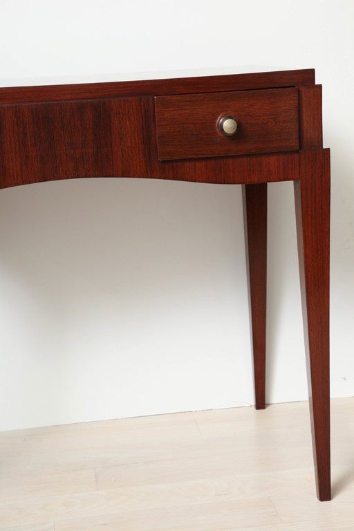 Elegant writing or vanity table with two frieze drawers, glass and brass knob handles and square tapered legs.