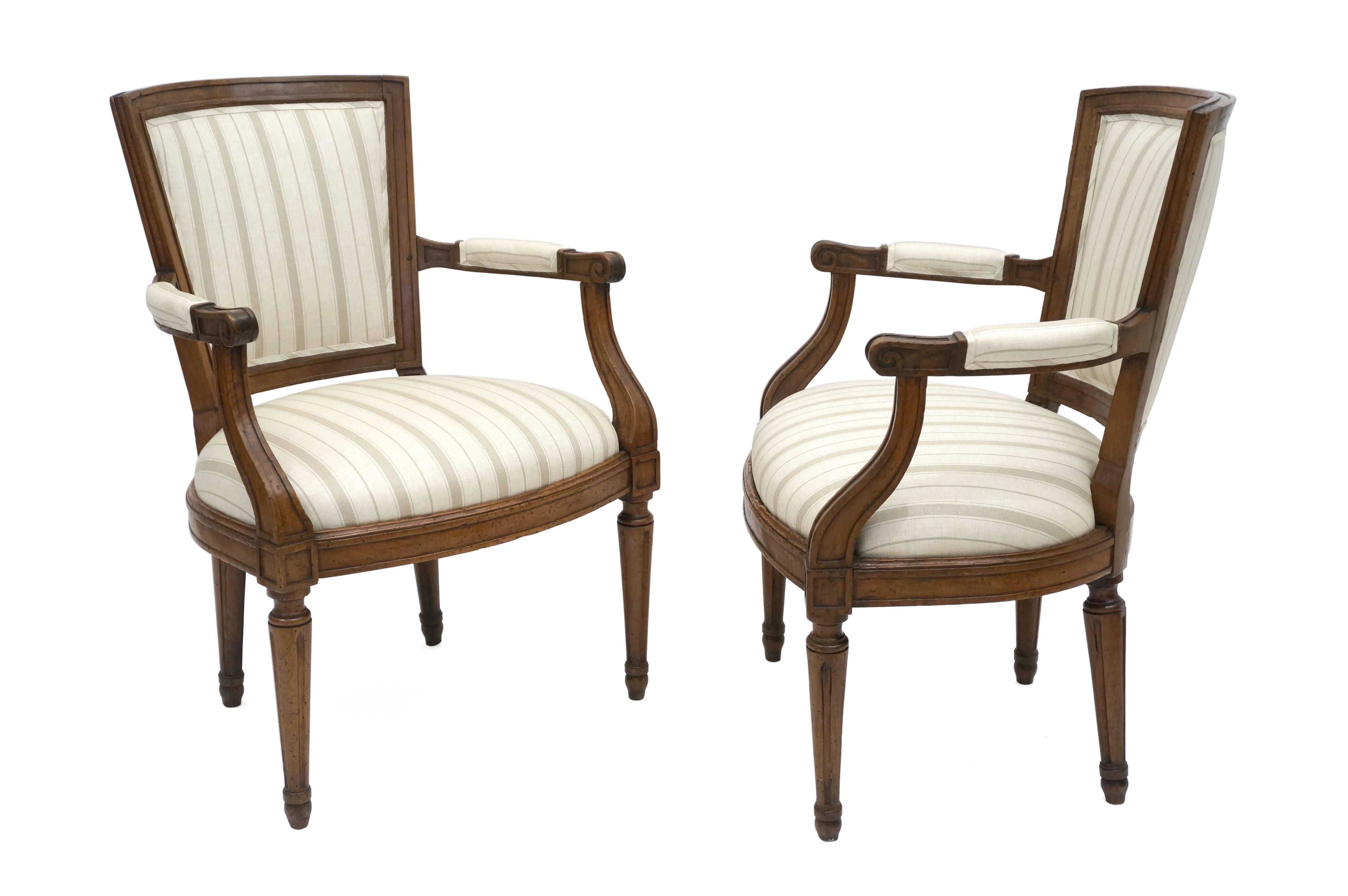 Pair of 18th century Italian walnut armchairs with newly upholstered seats and backs in a beige striped linen.