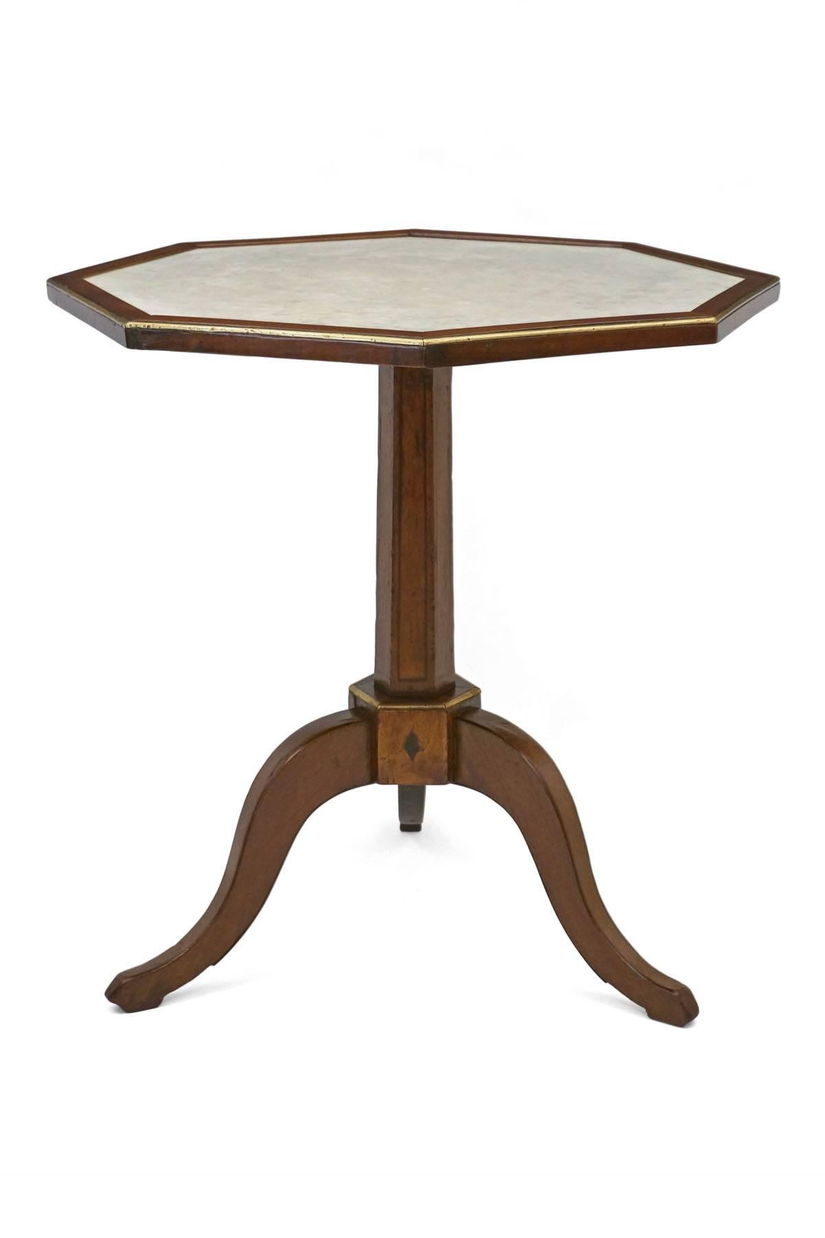 Walnut tripod table with octagonal top inset with original white marble and finished with brass trim.