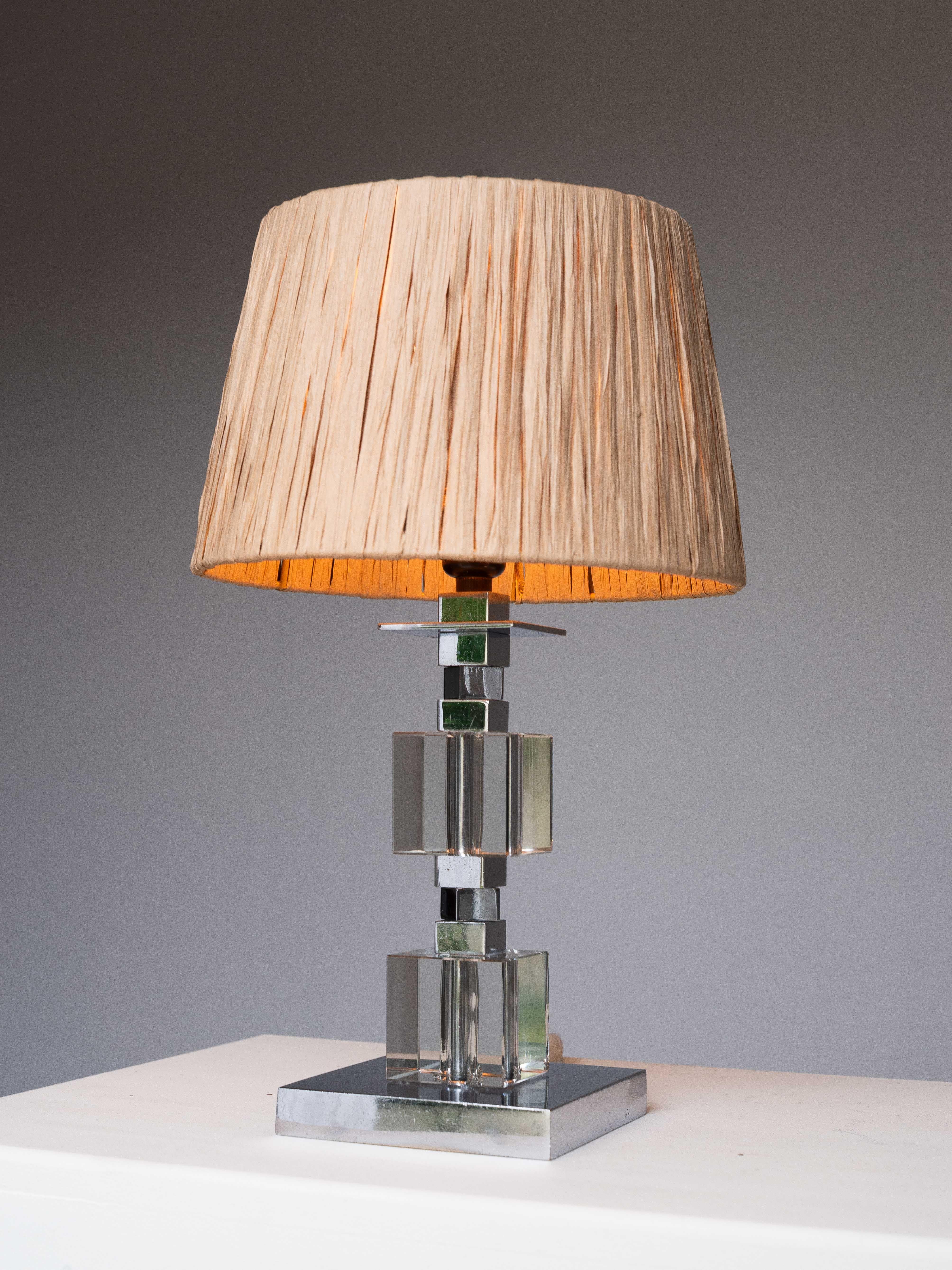 Art Deco Table Lamp - Chrome and Plexiglas - Jacques Adnet Style 1940s

Elegant Art Deco lamp made of plexiglass large cubes and chrome smaller cubes. 

The transparency creates a beautiful interplay of light and form. 

Chic design with its