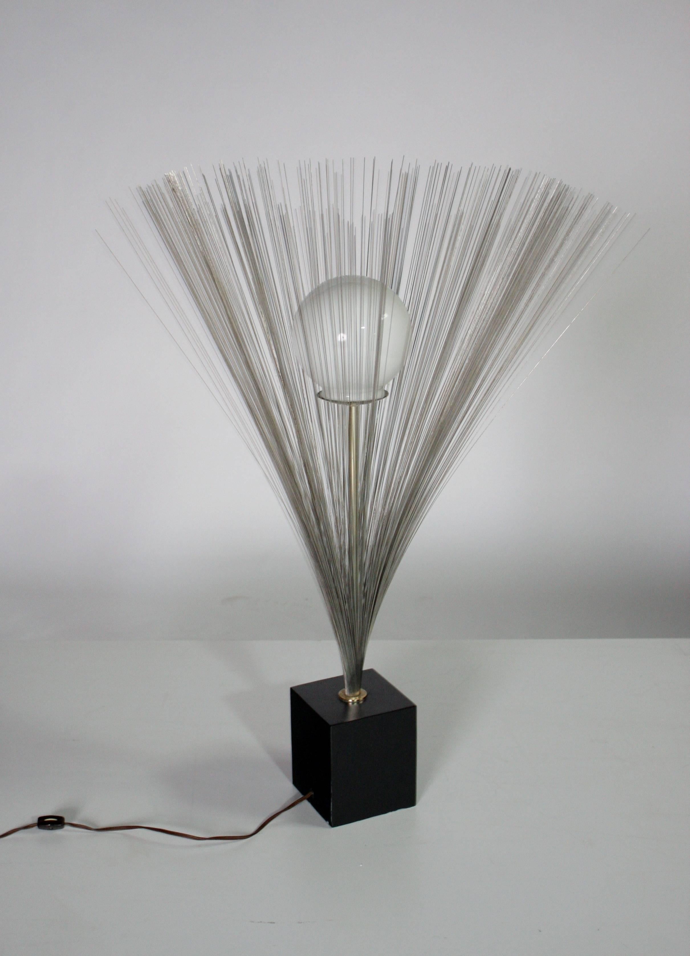 Mid-Century Modern spray sculpture table lamp in the style of Harry Bertoia with a round glass globe. Wired and in good working condition.