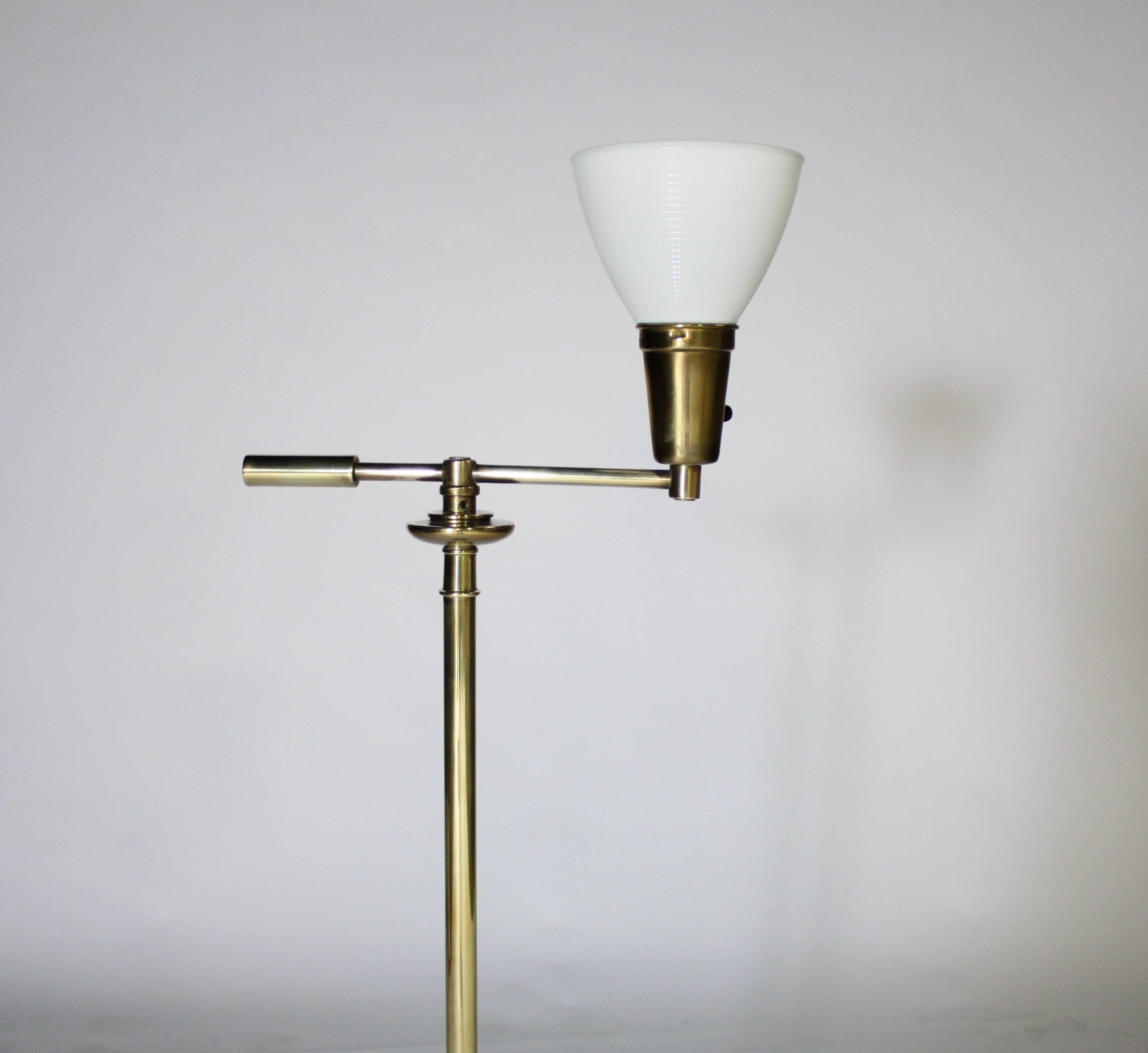 Vintage graduated brass ball floor lamp attributed to Tommi Parzinger by Stiffel. Hand polished with new cream color drum shade. Features Stiffel patent switch allows you to turn the lamp on and off by pushing down the long brass pole.