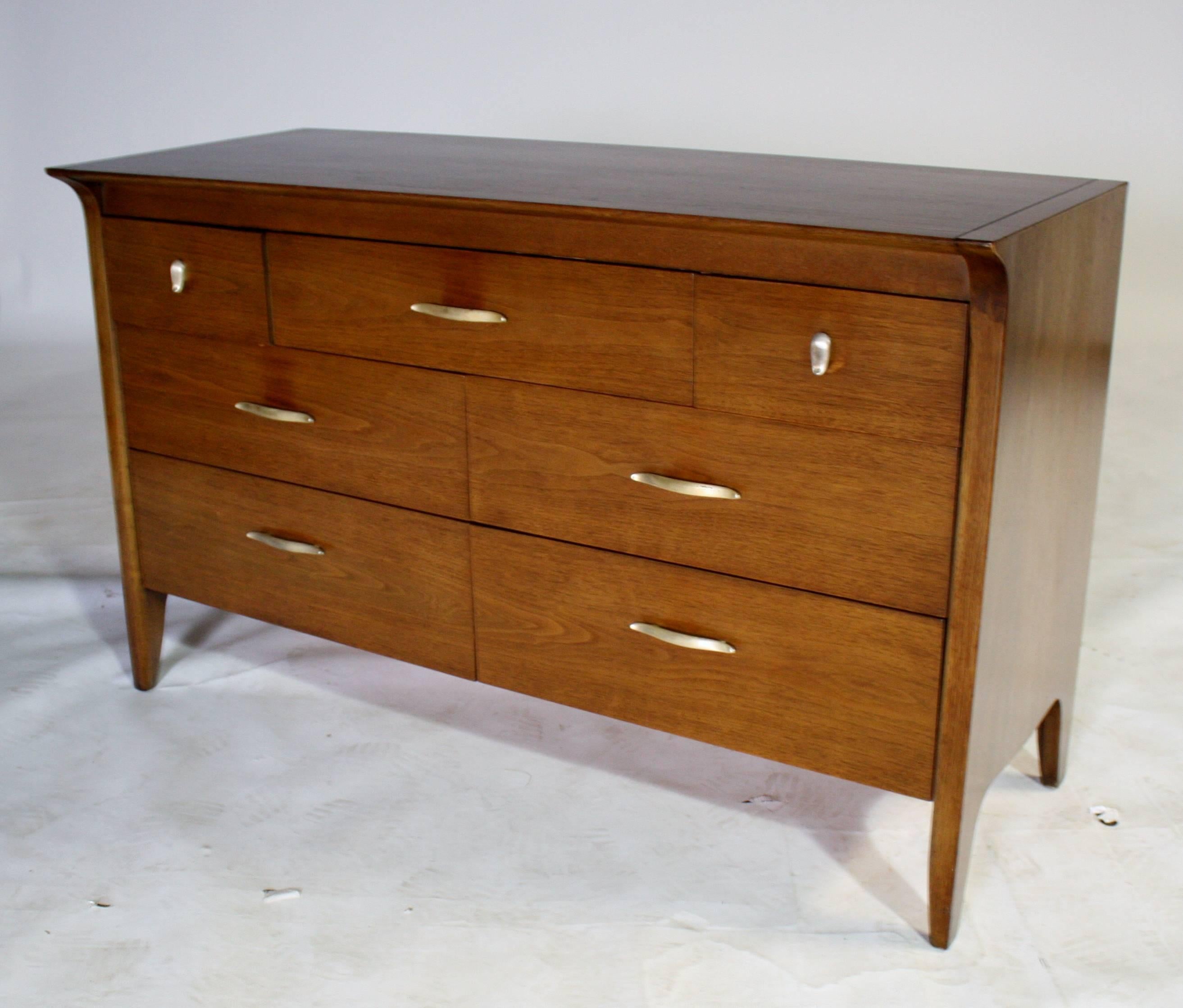 A Mid-Century Modern seven-drawer dresser in walnut designed by Danish architect John Van Koert for Drexel's 