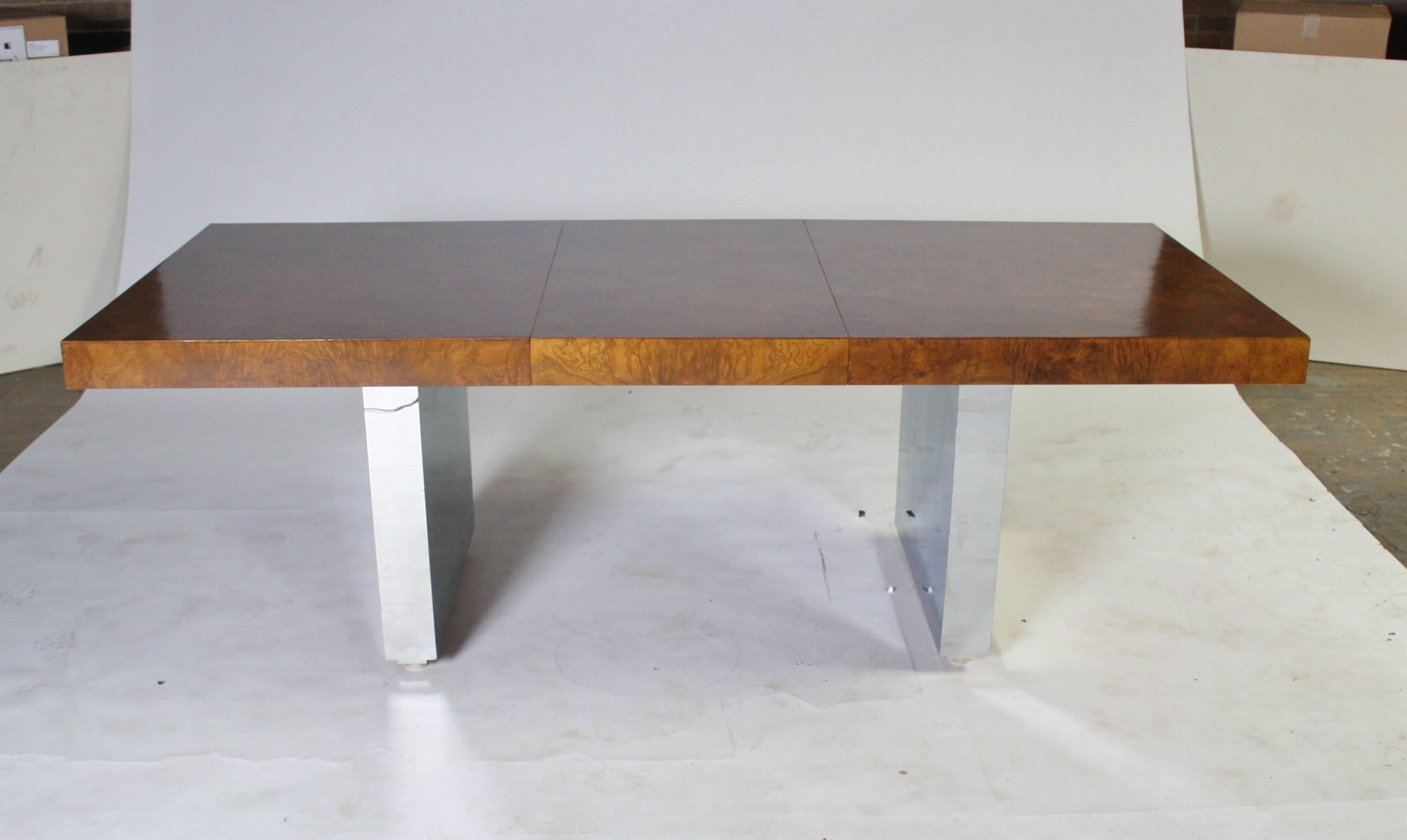 Very rare Milo Baughman style dining table by Roger Springer for Dunbar in a gorgeous walnut burl wood top with two leaves on a polished chrome base. Wood and chrome all in excellent condition. Table base has adjustable feet on glides and slides