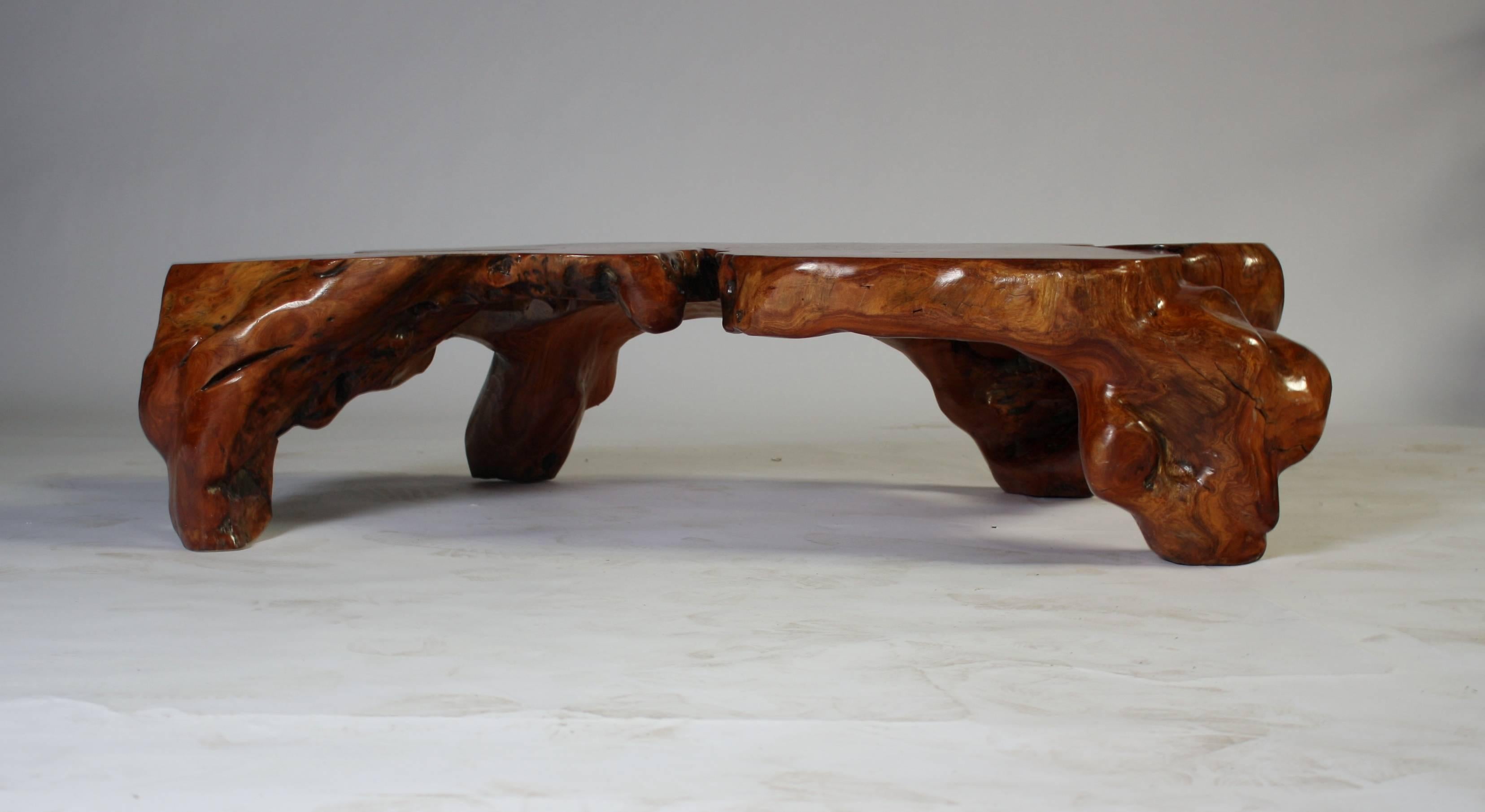 A natural wood cocktail table made from solid teak root.