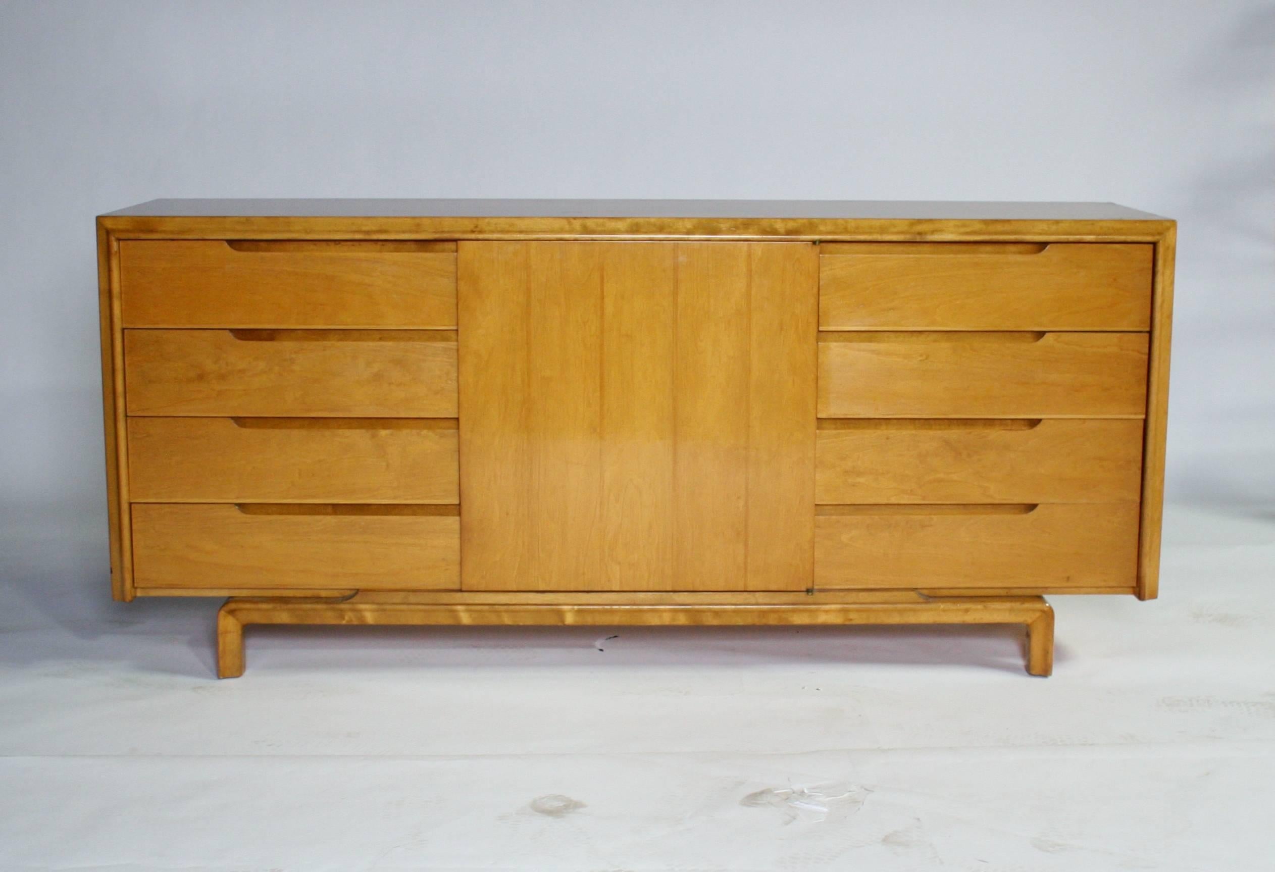 Gorgeous Mid-Century Swedish Modern sideboard made from flamed maple wood by Edmond Spence. Eight pull-out drawers and center concealed shelves with an additional cutlery pull-out drawer make this cabinet a highly versatile credenza dresser or