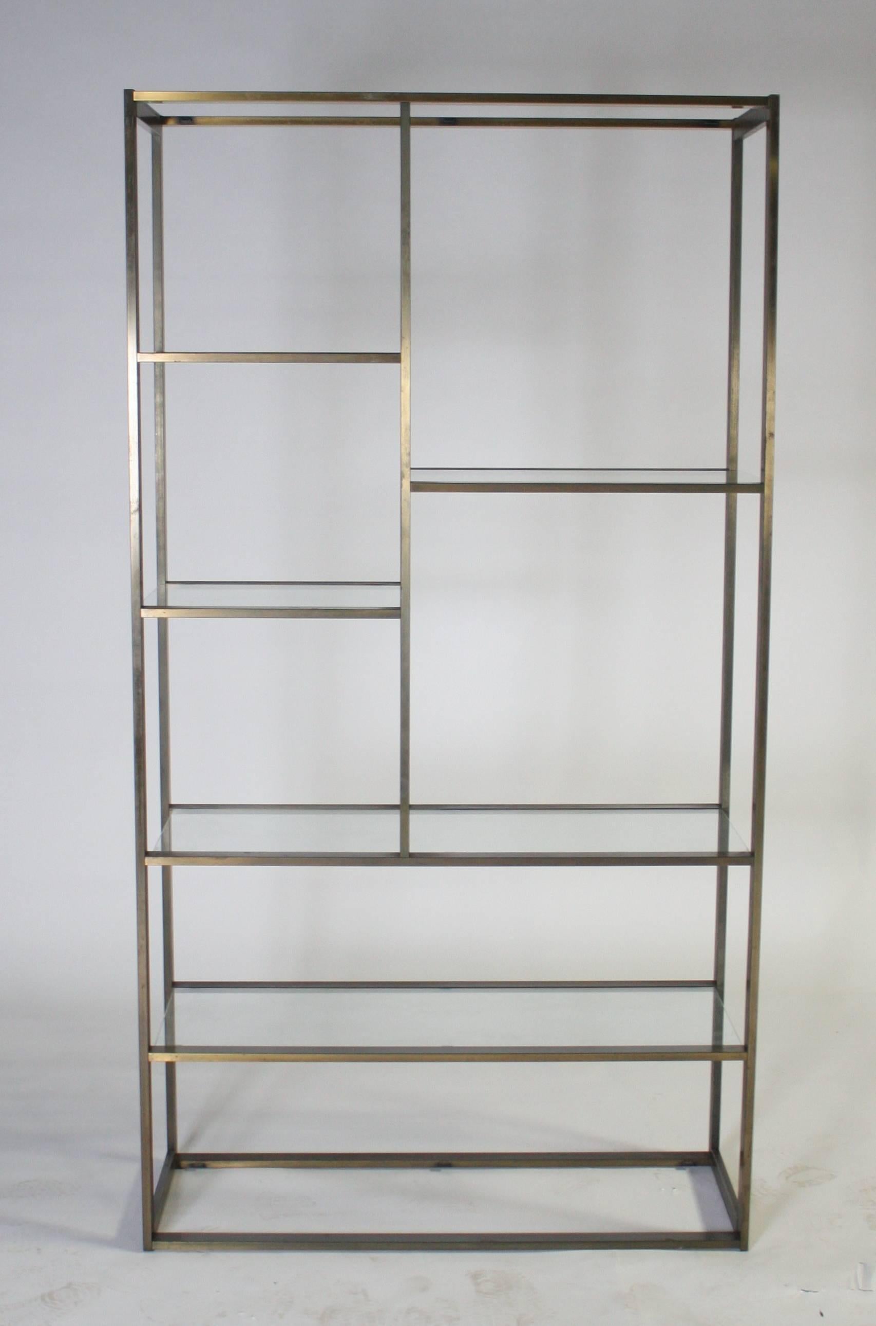 Tall Mid-Century Modern etagere attributed to Milo Baughman in bronze metal with seven glass shelves.
