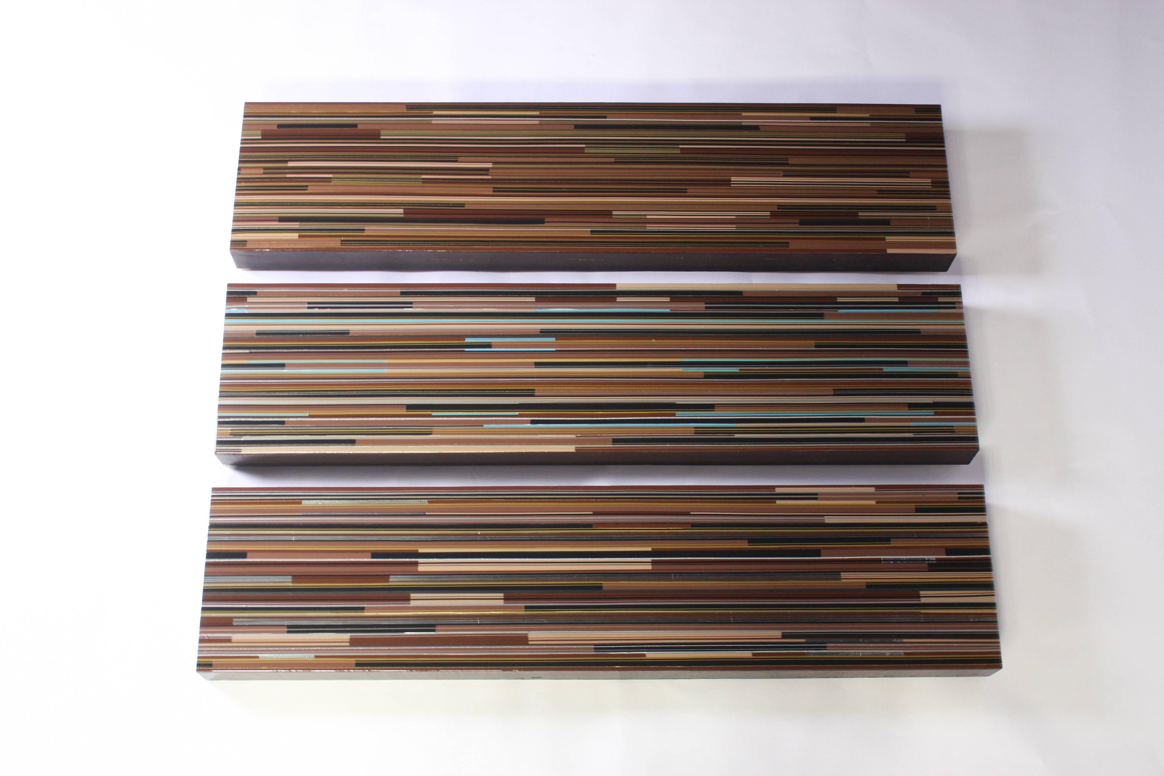 Three multimedia on board original paintings by artist/model Mel Platzke (1968-2016). Each panel is meticulously designed in multi-colored tape on board and finished in acrylic. Ready to hang, can be hung vertically or horizontally.
Measurements