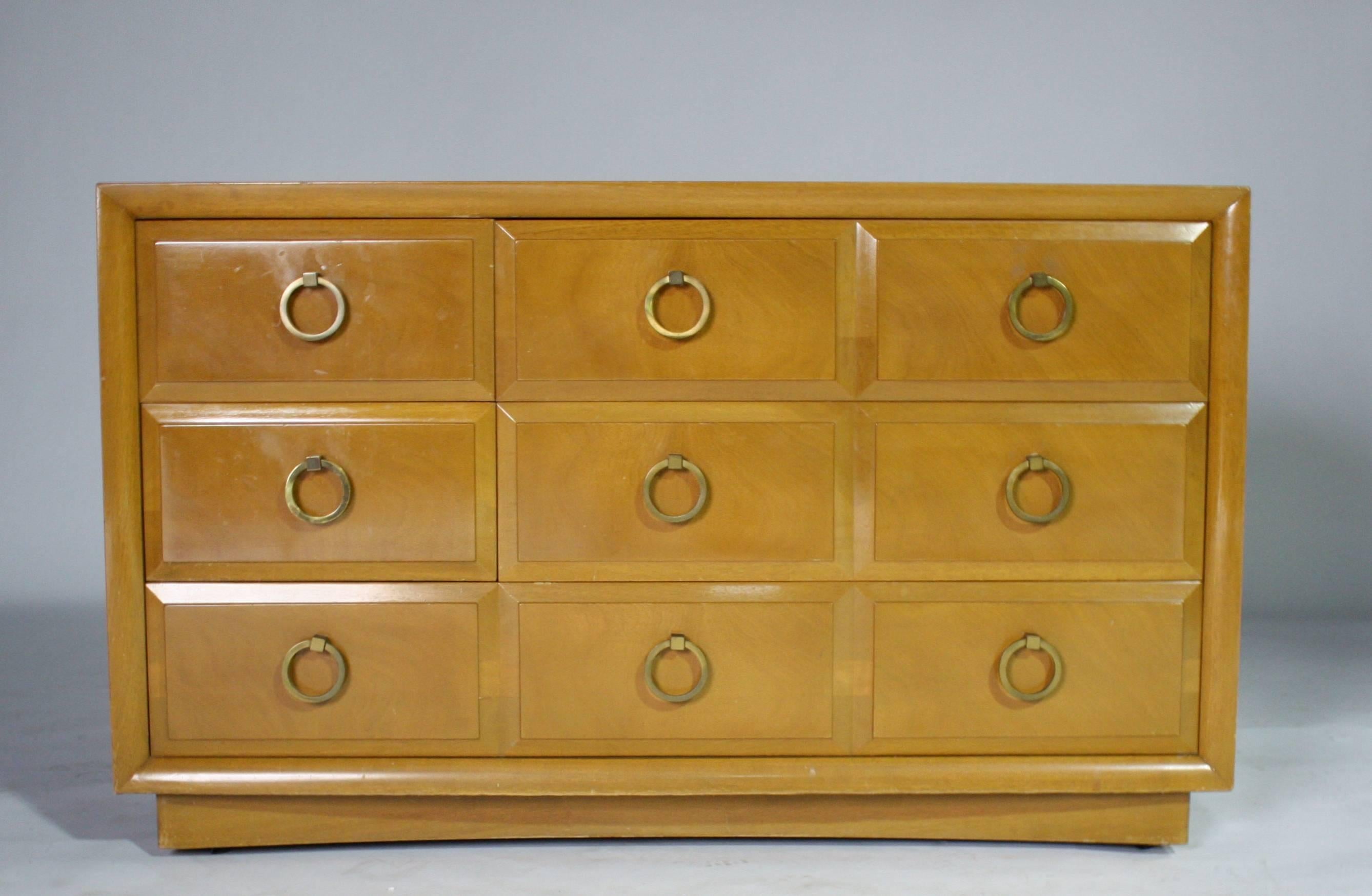 T.H. Robsjohn-Gibbings five-drawer dresser for Widdicomb on castors with brass pulls. Label inside the drawer.