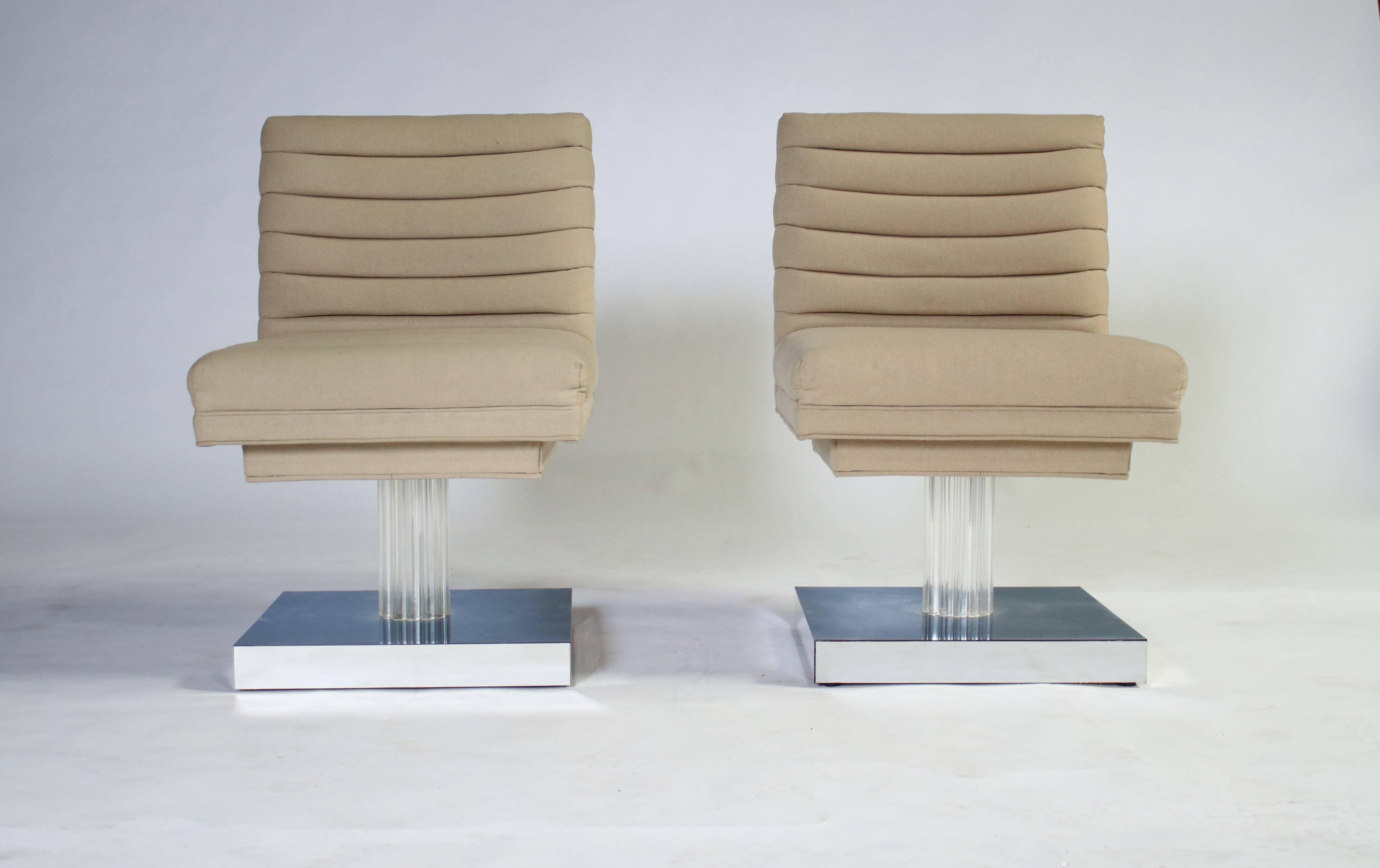 Unique 1970s swivel chairs on a Lucite and chrome plinth designed by Milo Baughman. Brilliant Space Age design with with channelled upholstered seating which rotates 360 degrees and in excellent condition.
                