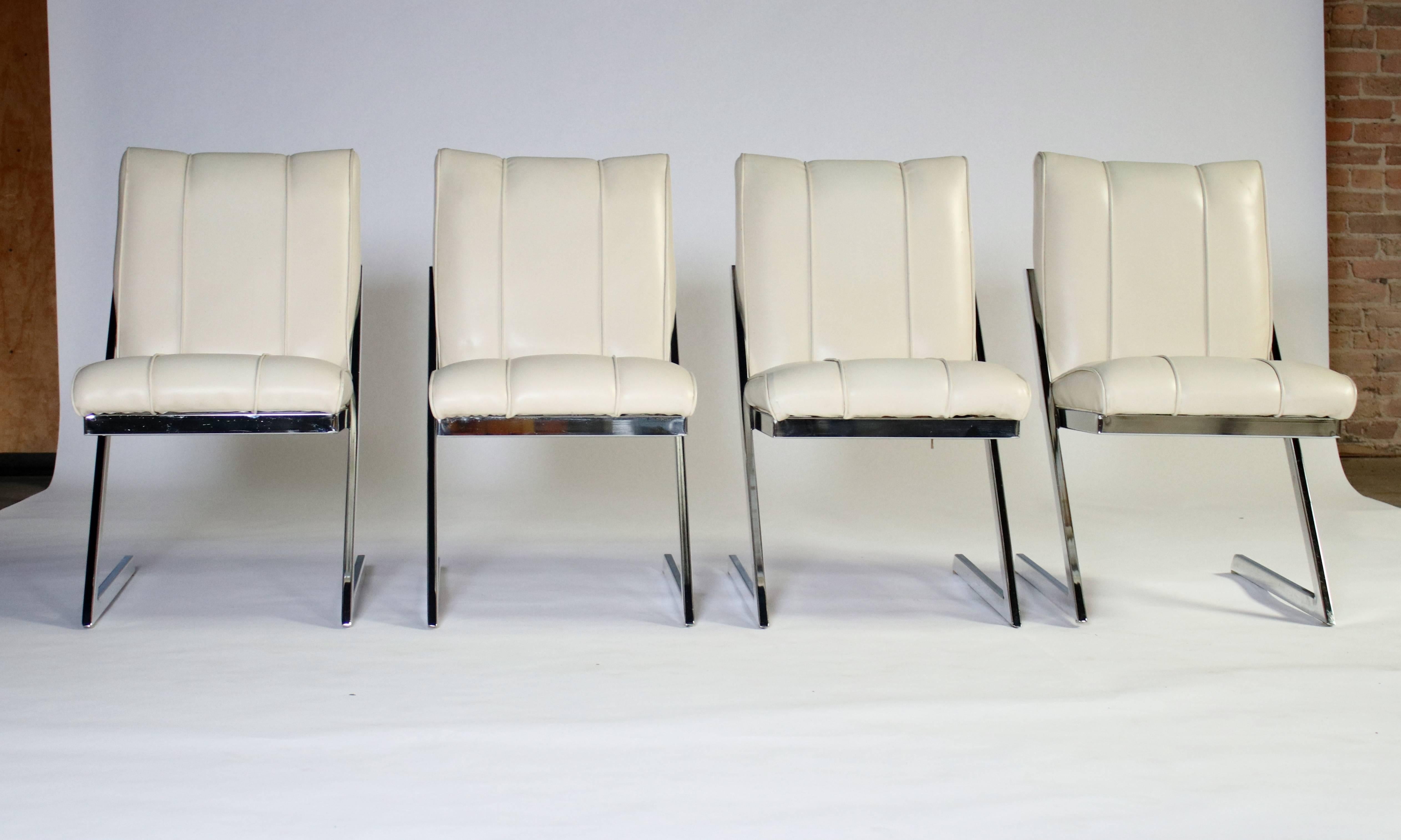 Set of four Mid-Century dining chairs in "z-frame" chrome and off-white vinyl. These authentic retro chairs are in great condition for their age.