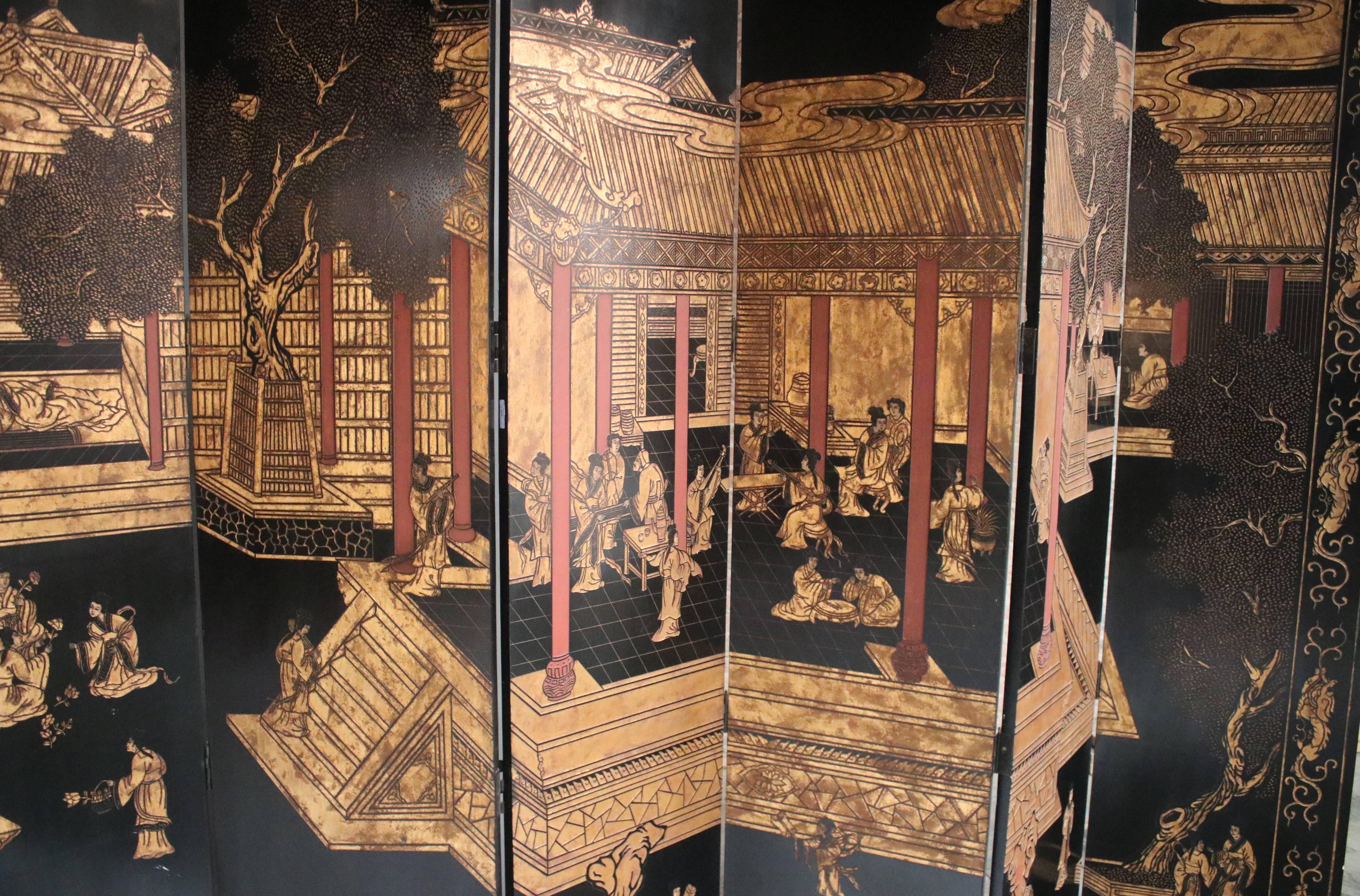 Monumental mid-20th century 12-panel Coromandel Chinese screen with a gold gilt on black lacquered courtyard scene and a bamboo / floral scene on the opposite side. Both sides show a lovely continual landscape painted on carved lacquer wood. All