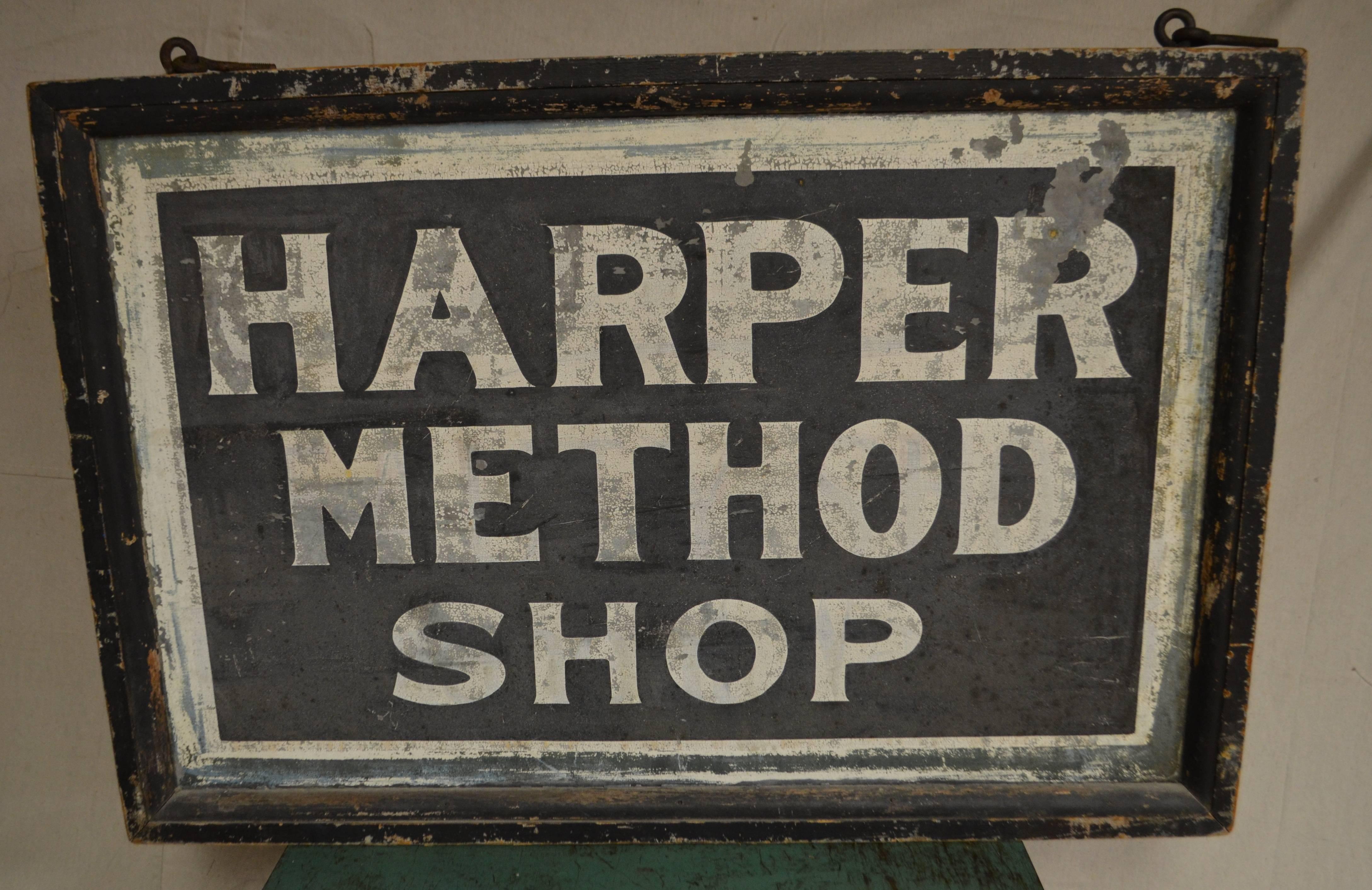 Rare two-sided sign for a shop created by Martha Matilda Harper. Framed in wood with worn black paint. The signage is paint on metal with white lettering against black and traces of blue coming through.

There's a fascinating back story