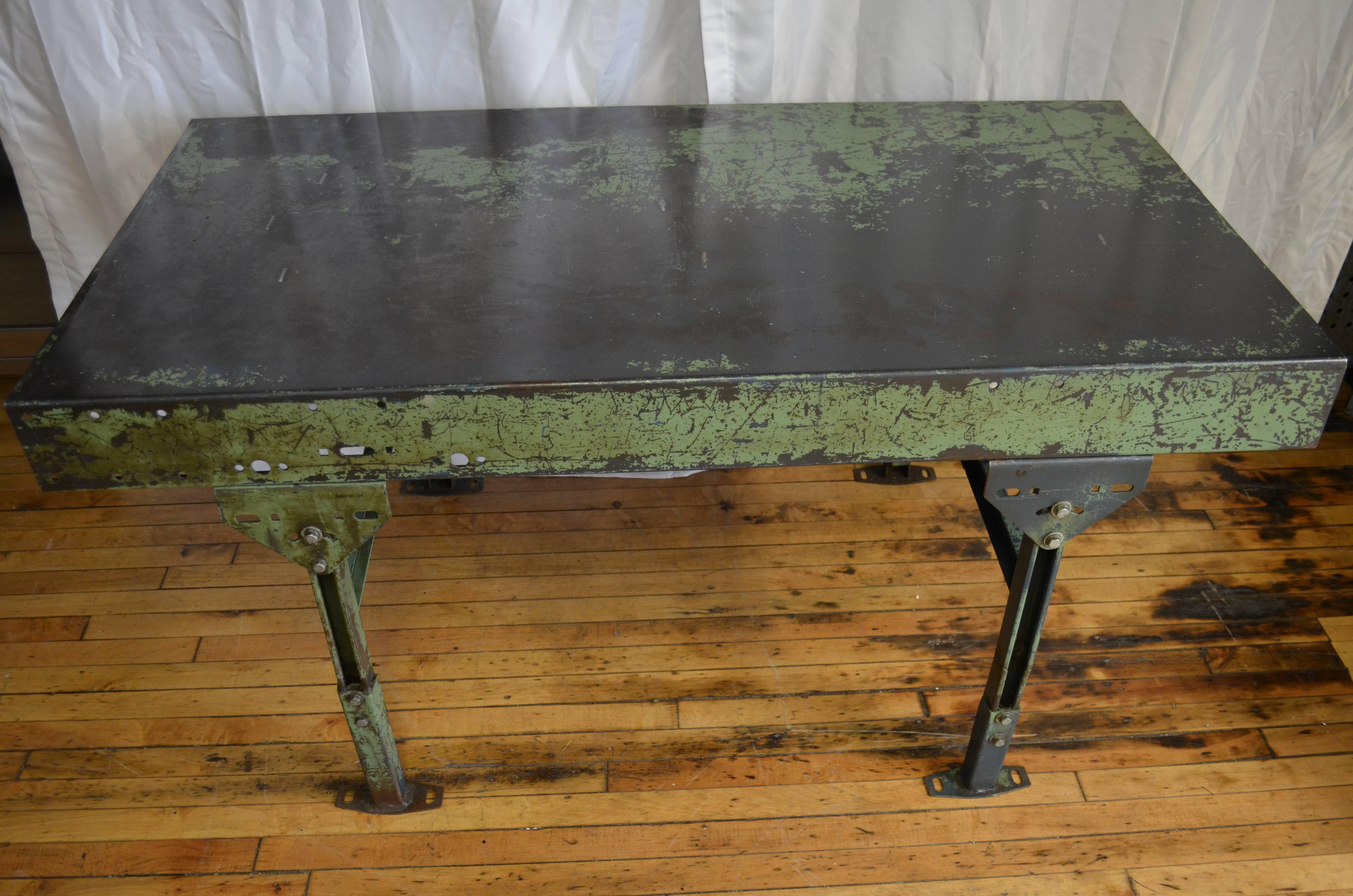 Factory worktable in as-found green paint has legs that adjust from 30
